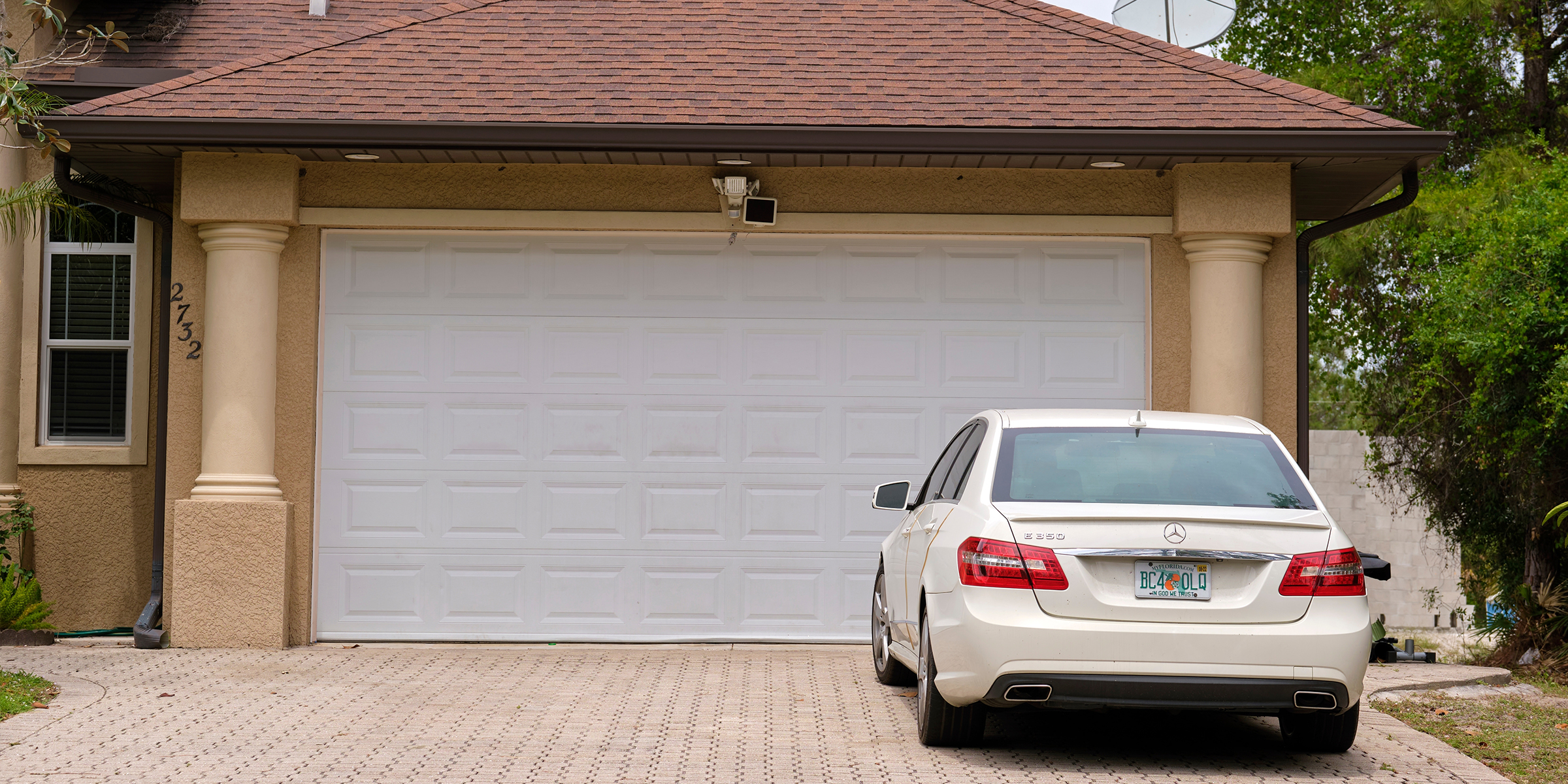 Un automóvil aparcado en la puerta de un garaje doble | Fuente: Shutterstock