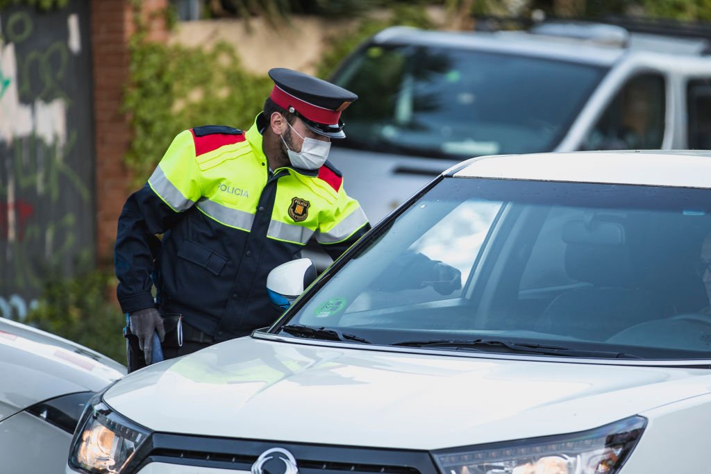 Un miembro de la policía catalana Mossos d'Esquadra lleva a cabo un control de tráfico para evitar desplazamientos no permitidos durante el confinamiento. | Foto de Xavi Torrent vía Getty Images