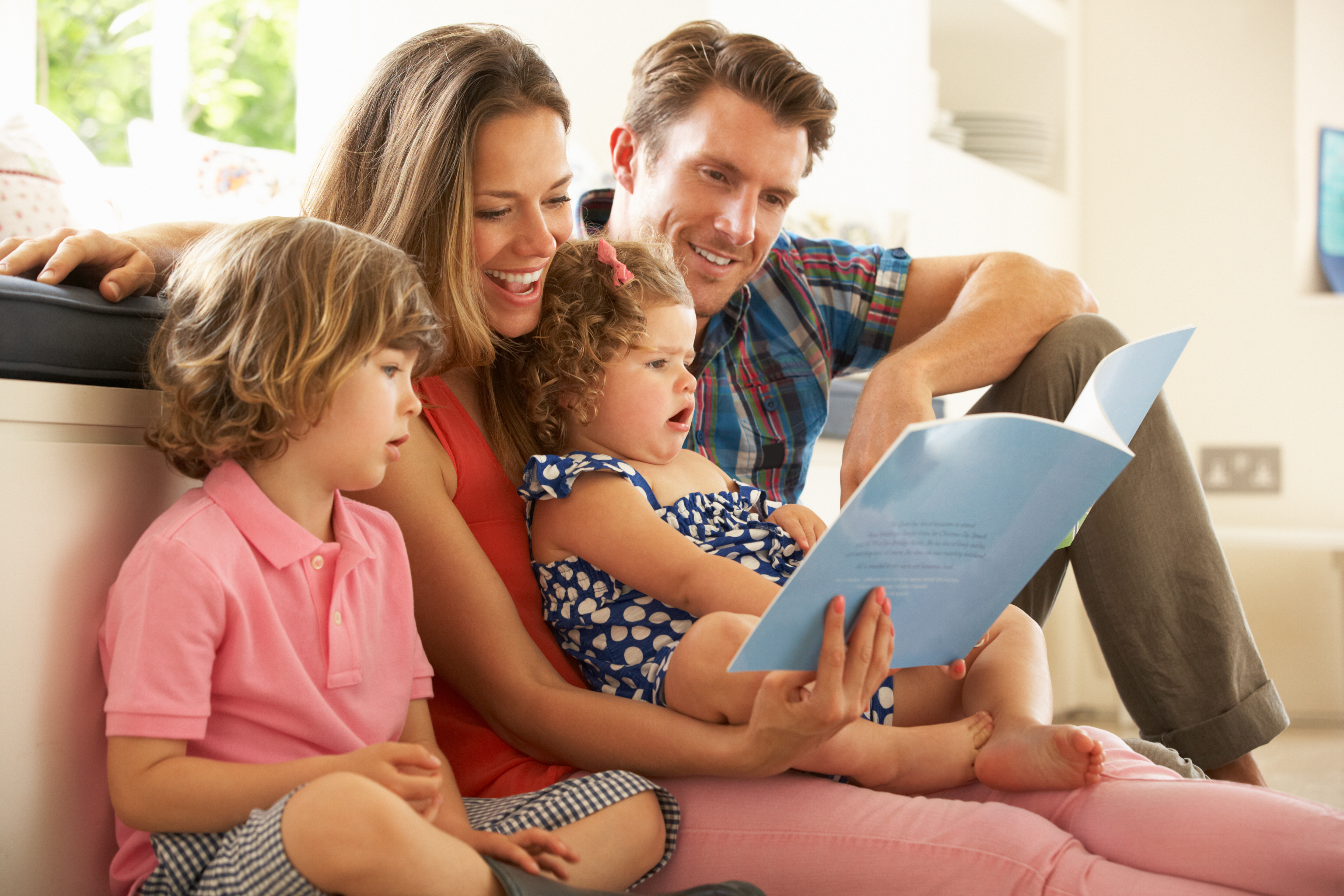 Una familia leyendo un libro juntos | Foto: Shutterstock