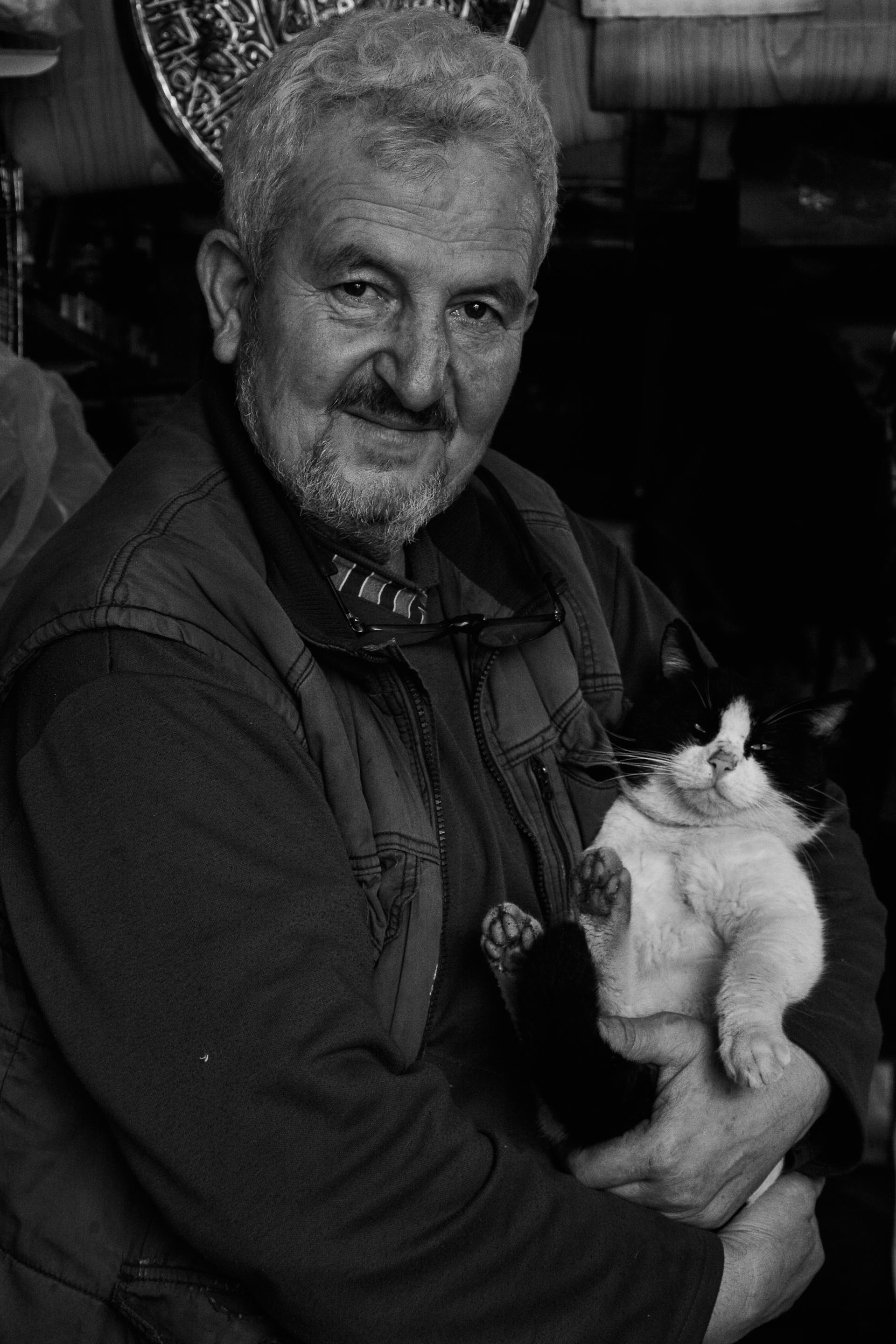 Un anciano con un gato en brazos | Fuente: Pexels