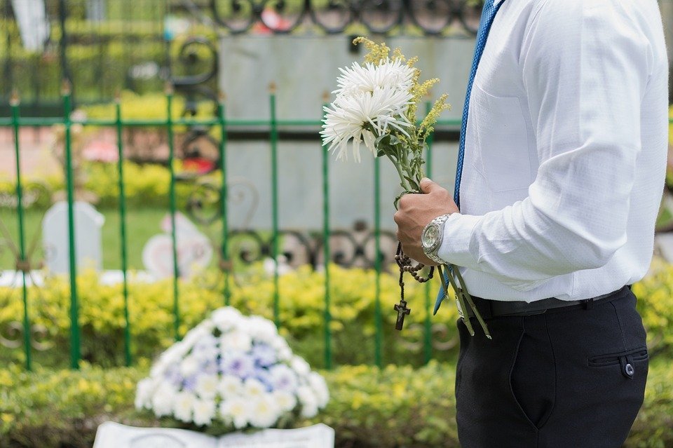 Hombre con flores en el cementerio | Foto: Max Pixel