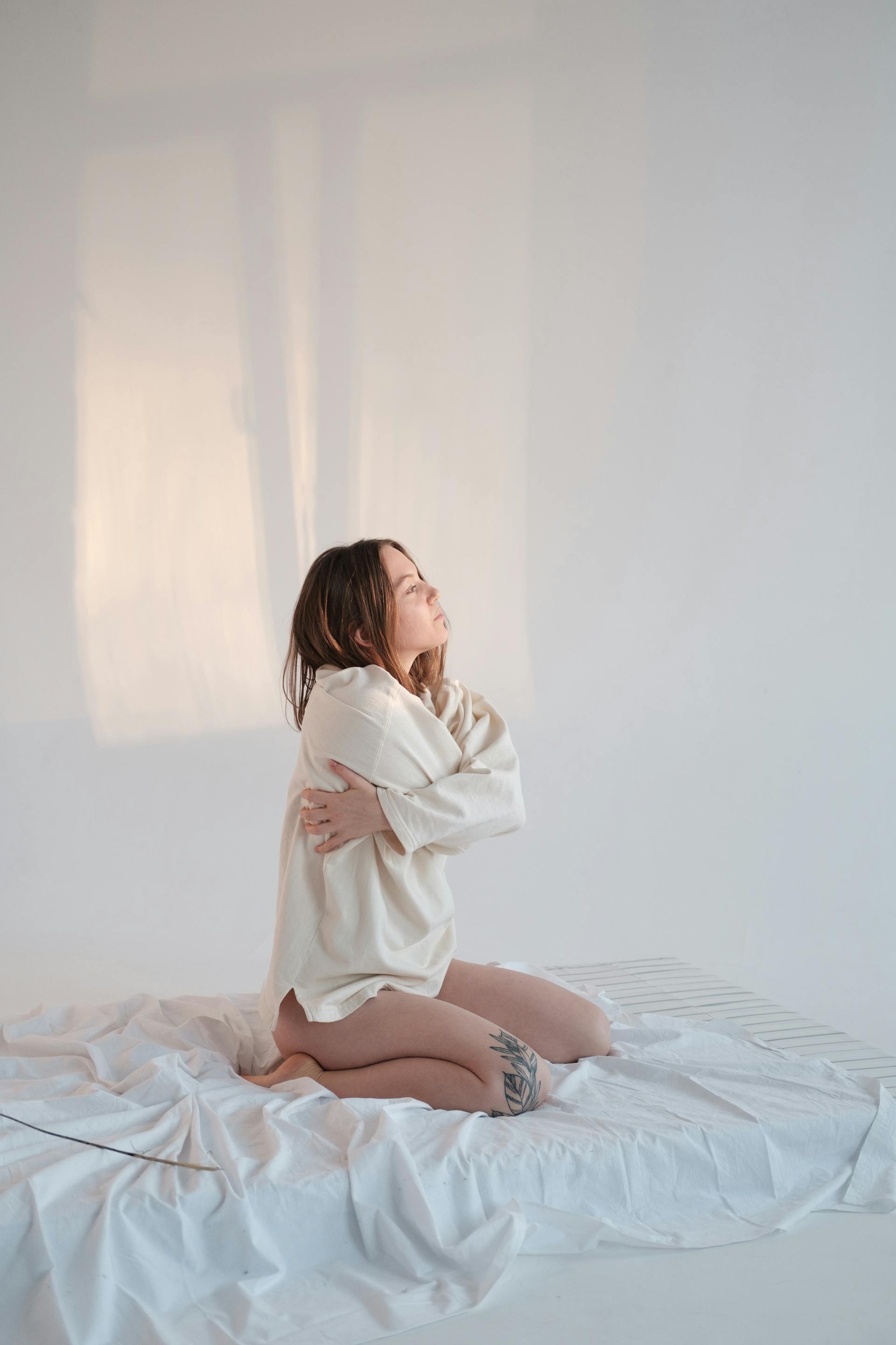 Una mujer arrodillada en una cama | Fuente: Pexels