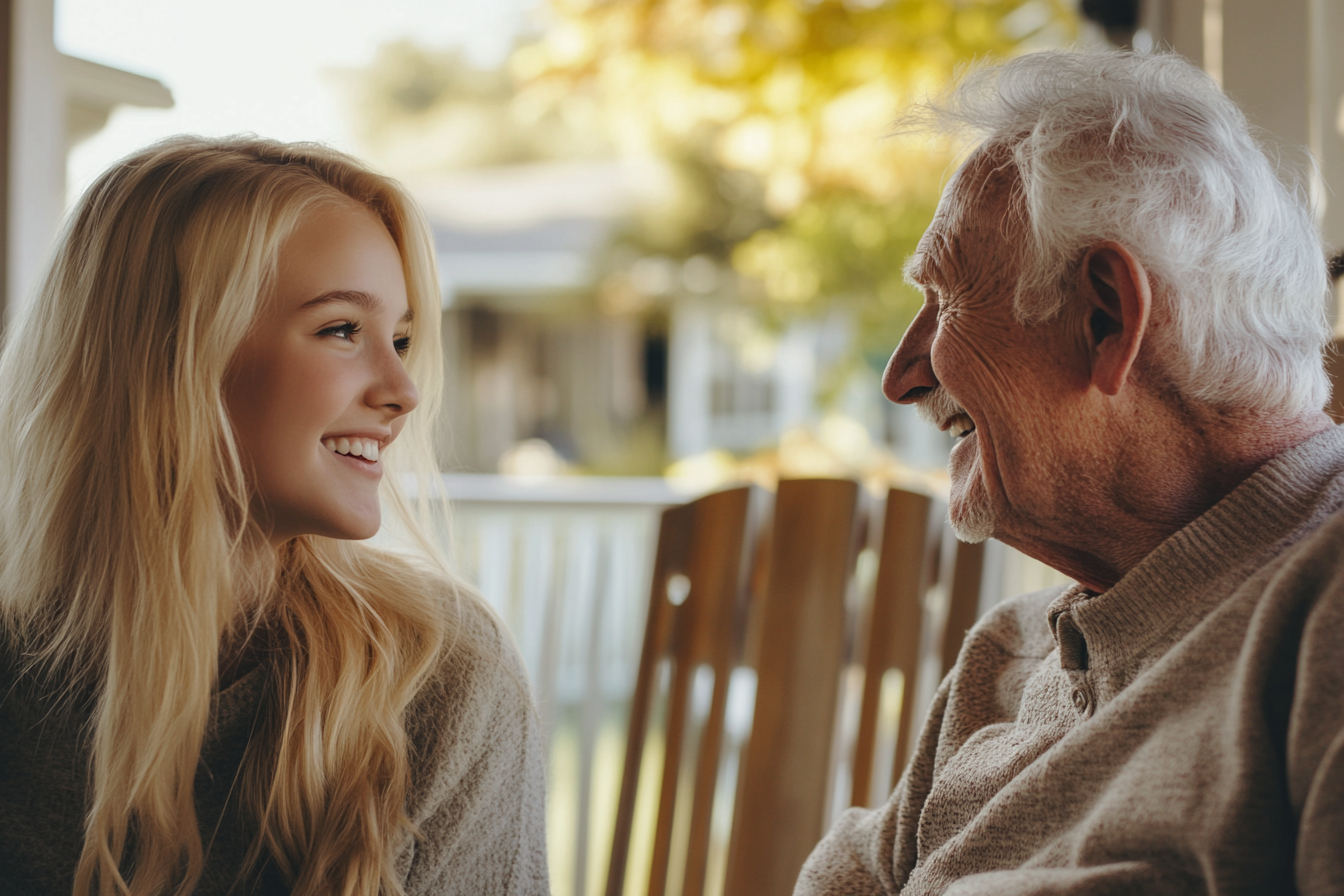 Una joven sentada en un porche con su abuelo | Fuente: Midjourney