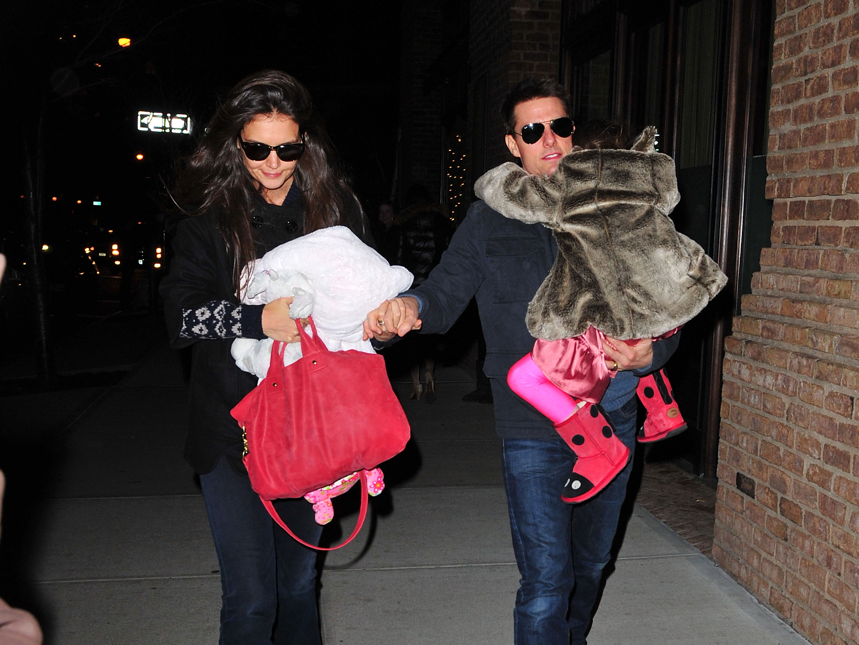 Katie Holmes, Tom Cruise y Suri Cruise en las calles de Manhattan en Nueva York, el 17 de diciembre de 2011 | Foto: Getty Images