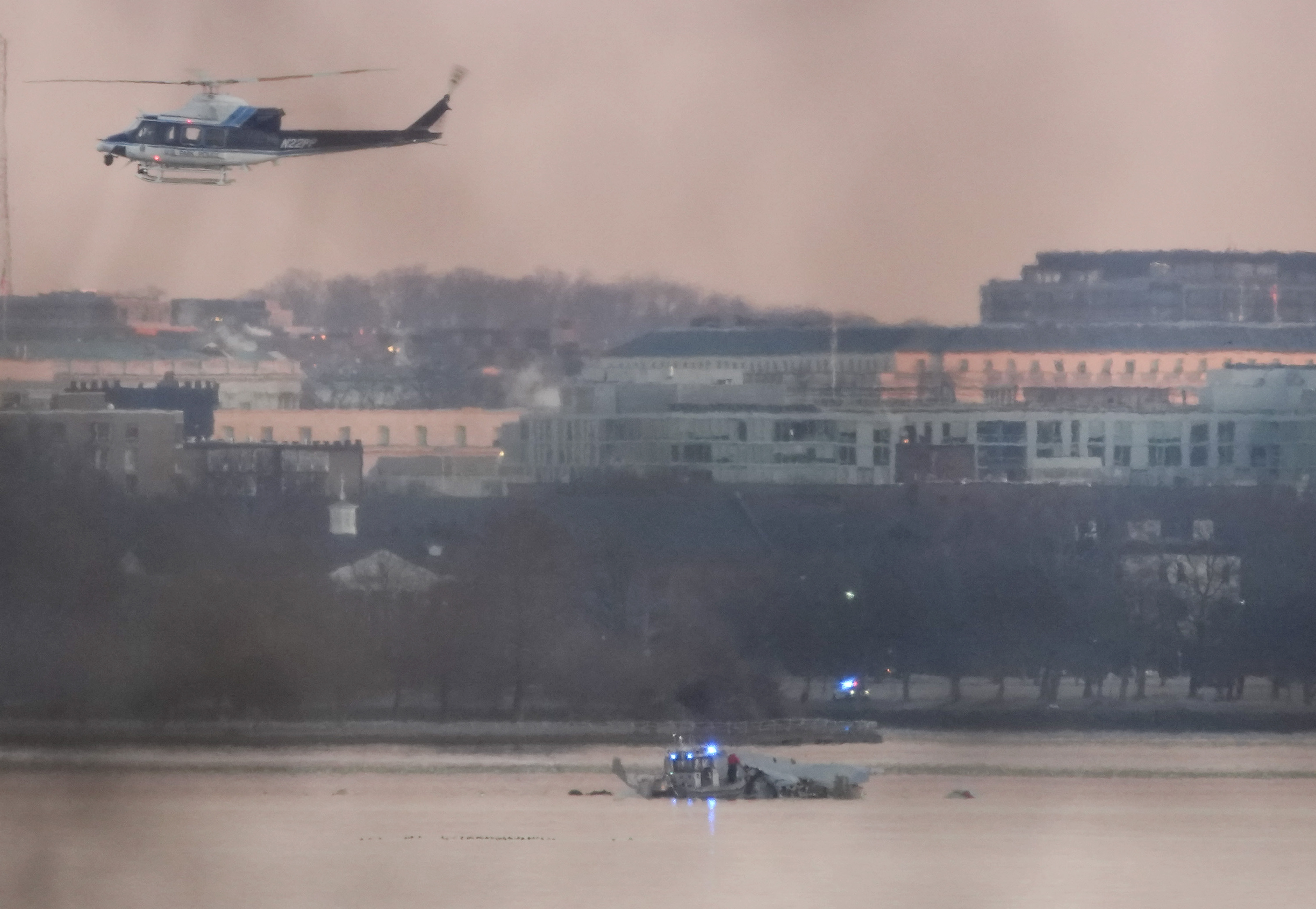 Un helicóptero sobrevolando el lugar del accidente aéreo en Arlington, Virginia, el 30 de enero de 2025. | Fuente: Getty Images