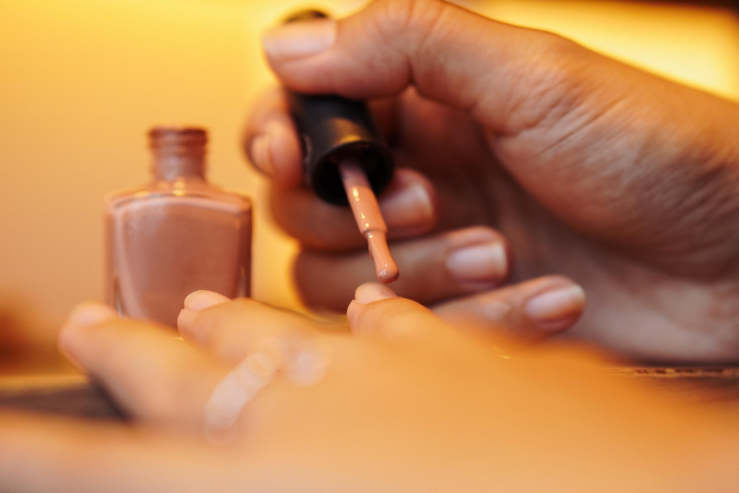Una persona aplicándose la manicura | Fuente: Shutterstock
