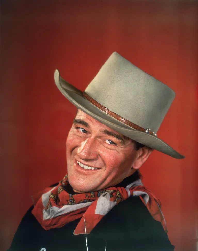 Un retrato de estudio de John Wayne vestido con ropa occidental, con la cabeza girada hacia un lado, alrededor de 1955. | Foto: Getty Images