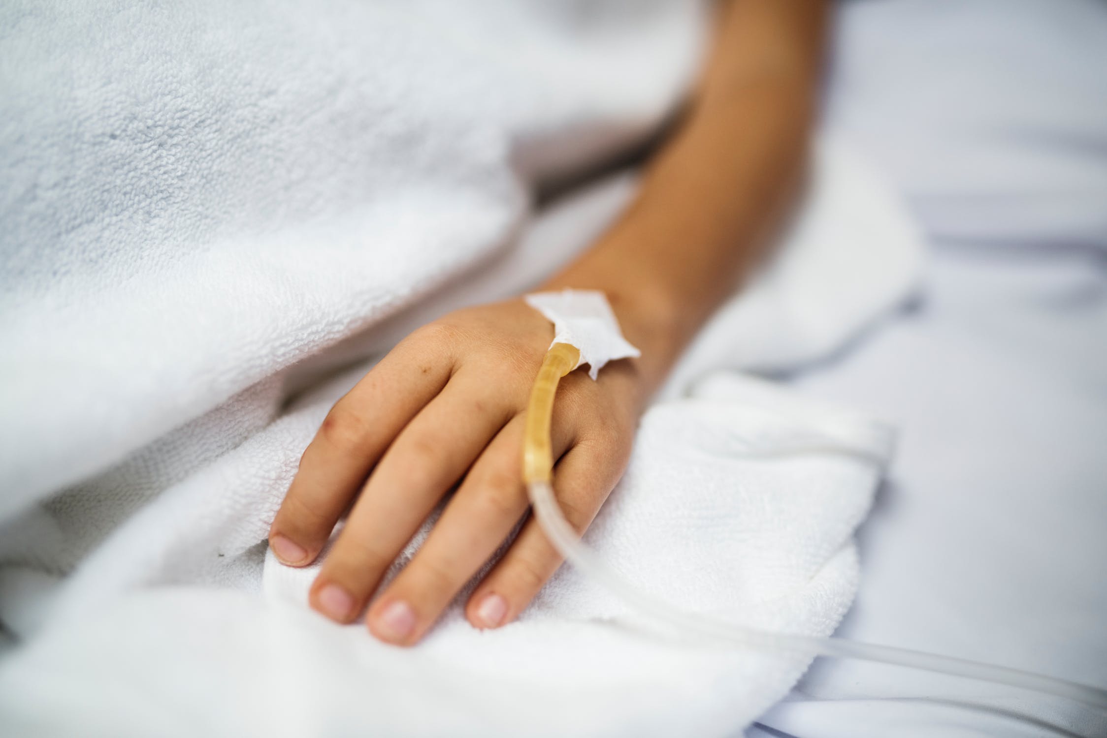 Niño en cama de hospital con cateter en brazo. | Imagen: Pexels