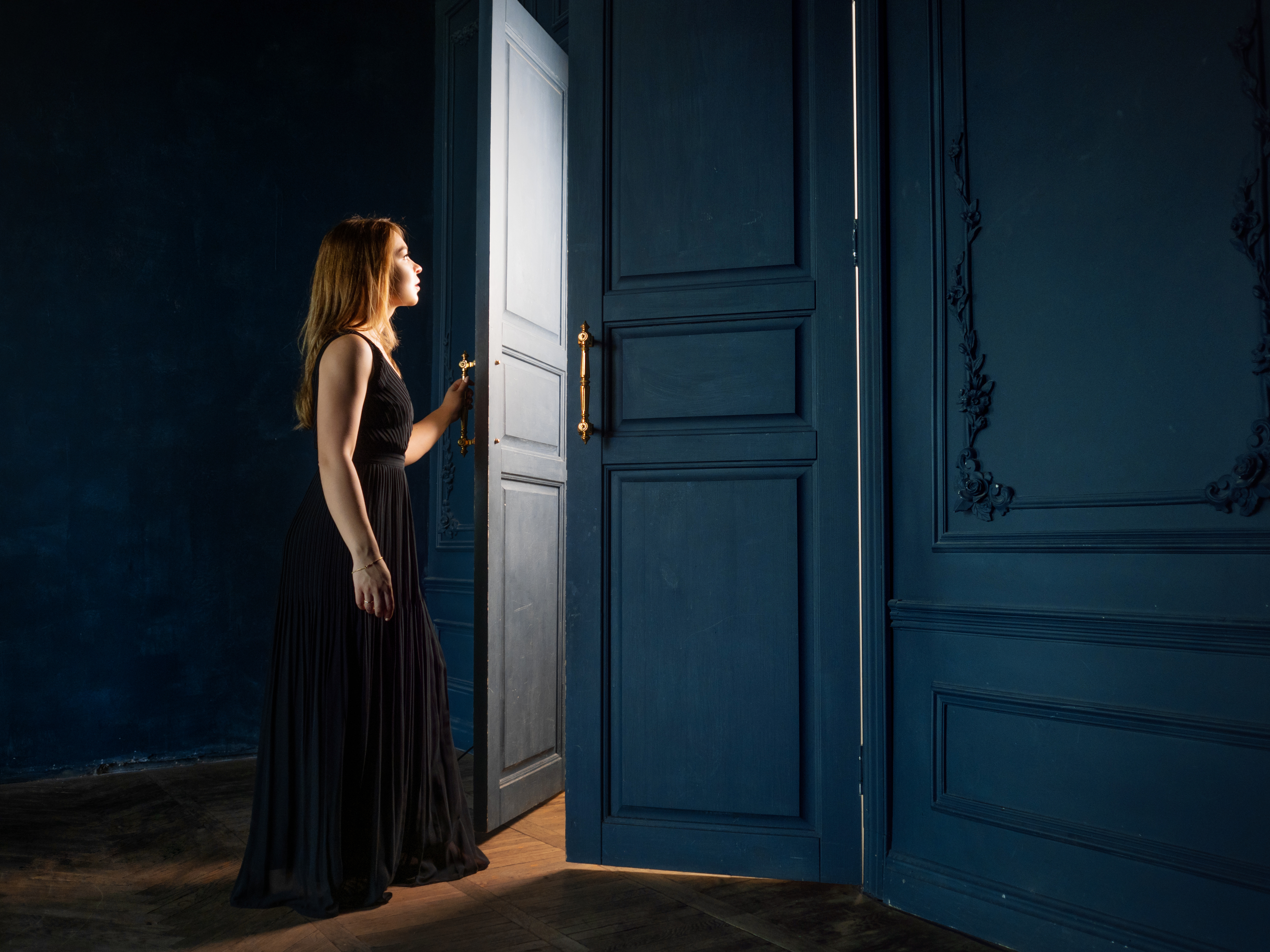 Mujer abriendo la puerta de una habitación | Foto: Shutterstock