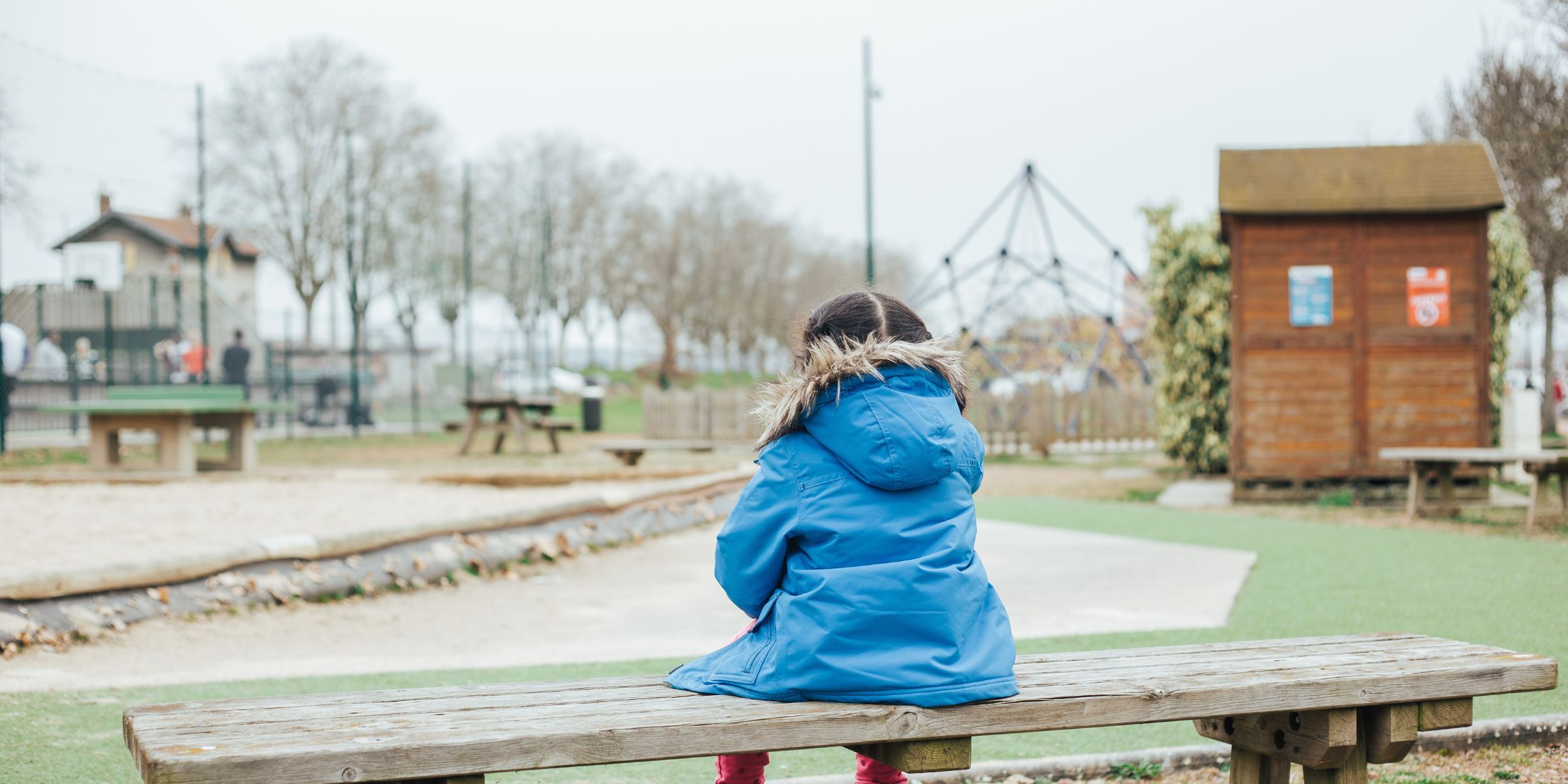 Una chica sentada en un banco en un parque | Fuente: Shutterstock