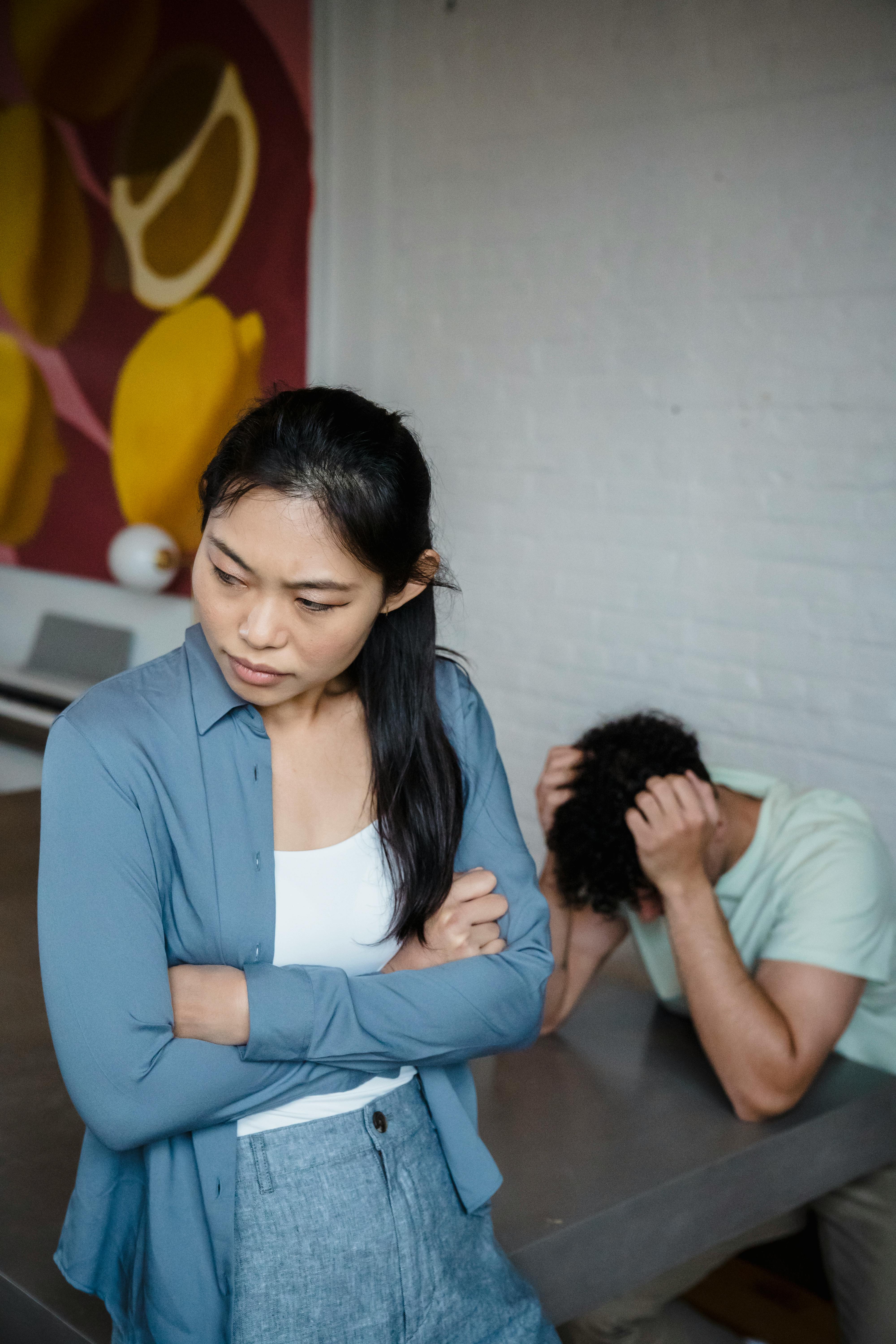 Una mujer y un hombre con la cabeza entre las manos | Fuente: Pexels