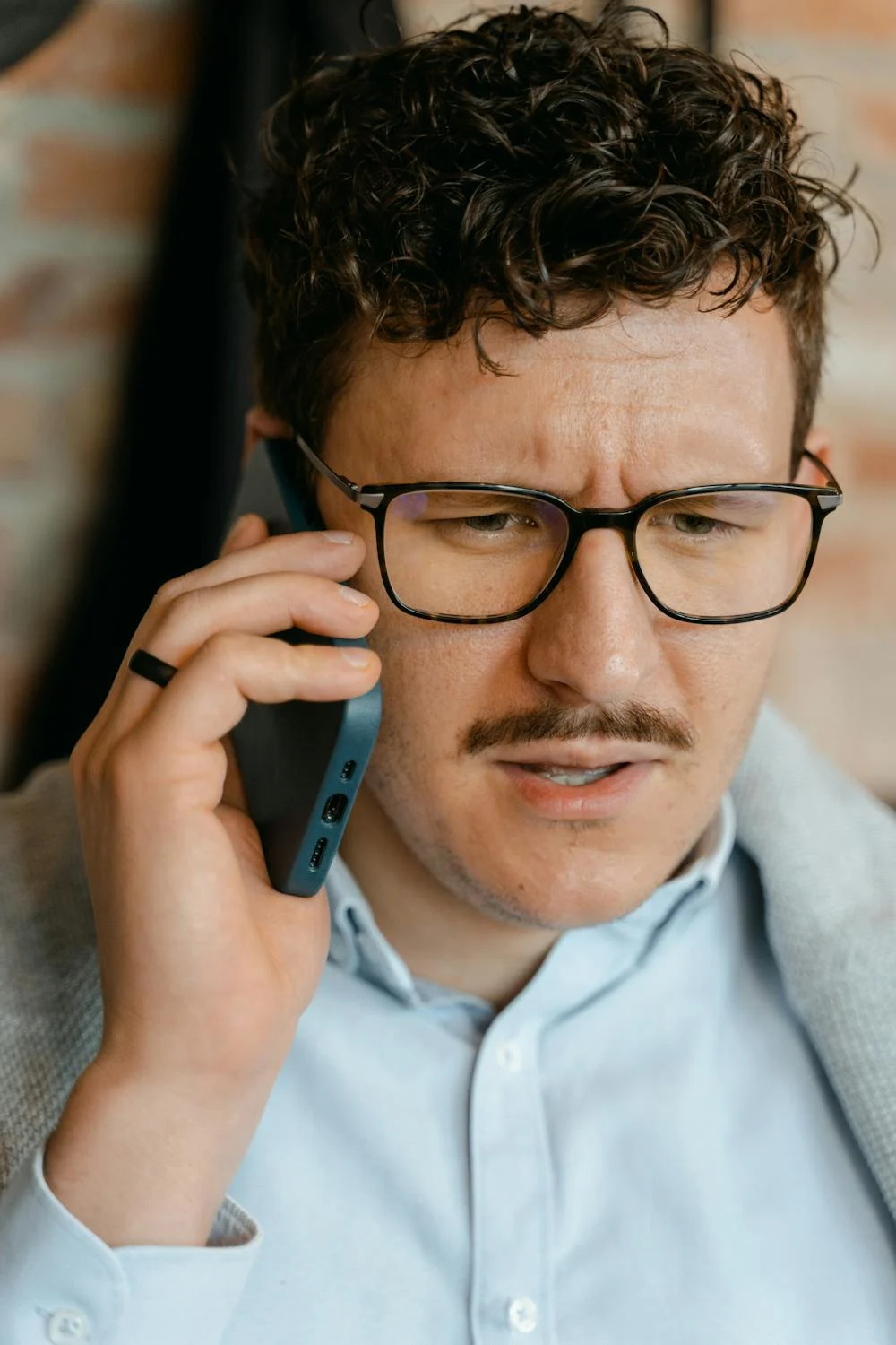 Un hombre con el ceño fruncido hablando por teléfono | Fuente: Pexels