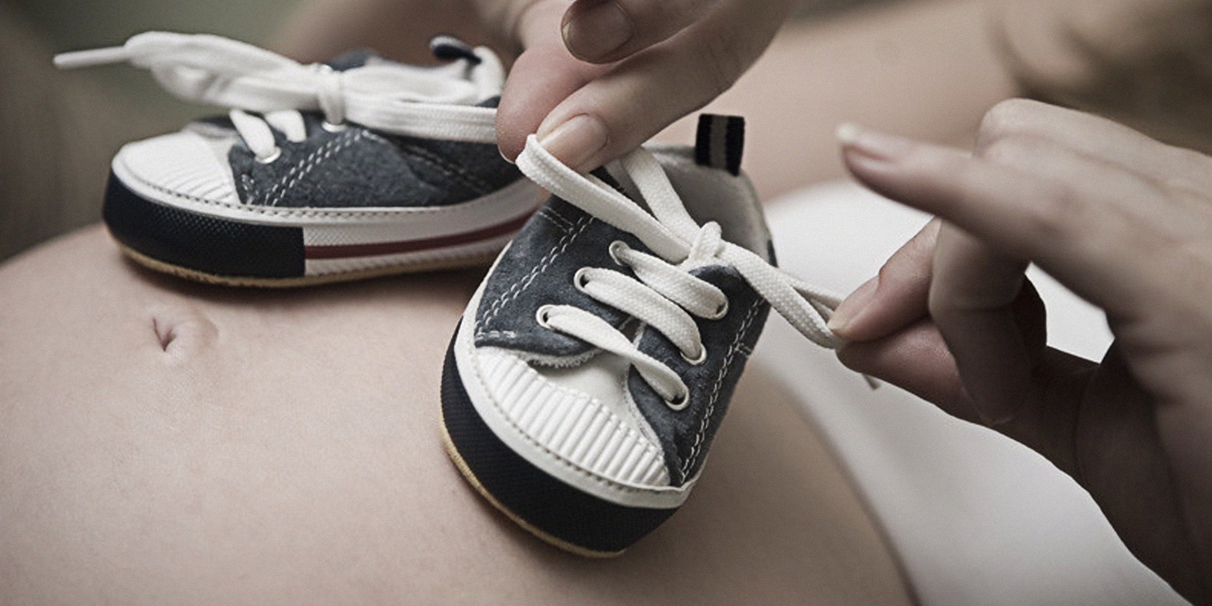 Zapatos de bebé en el vientre de una embarazada | Foto: Flickr.com/Meagan (CC BY 2.0)