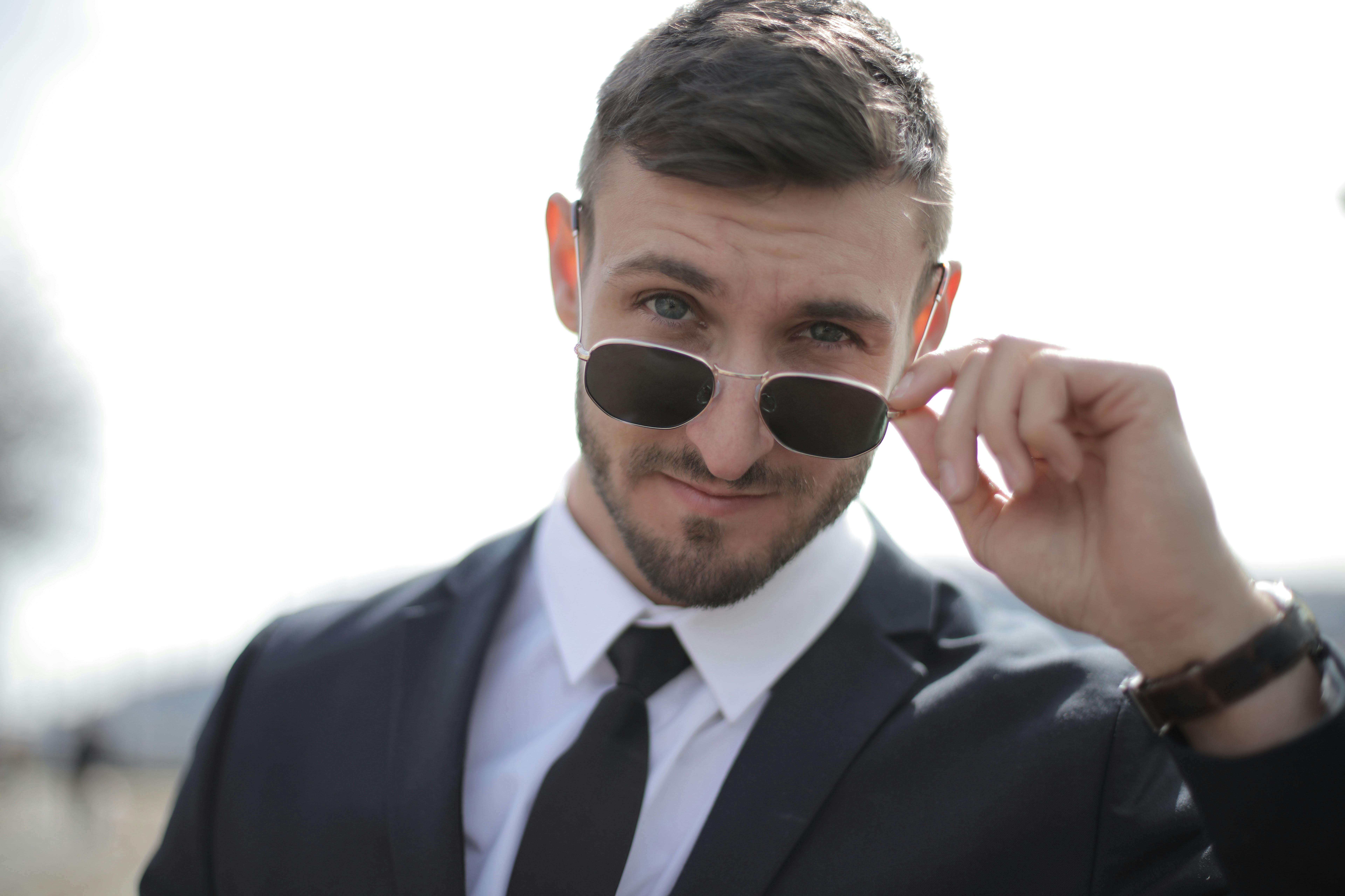Un uomo arrogante che sbircia sopra i suoi occhiali | Fonte: Pexels