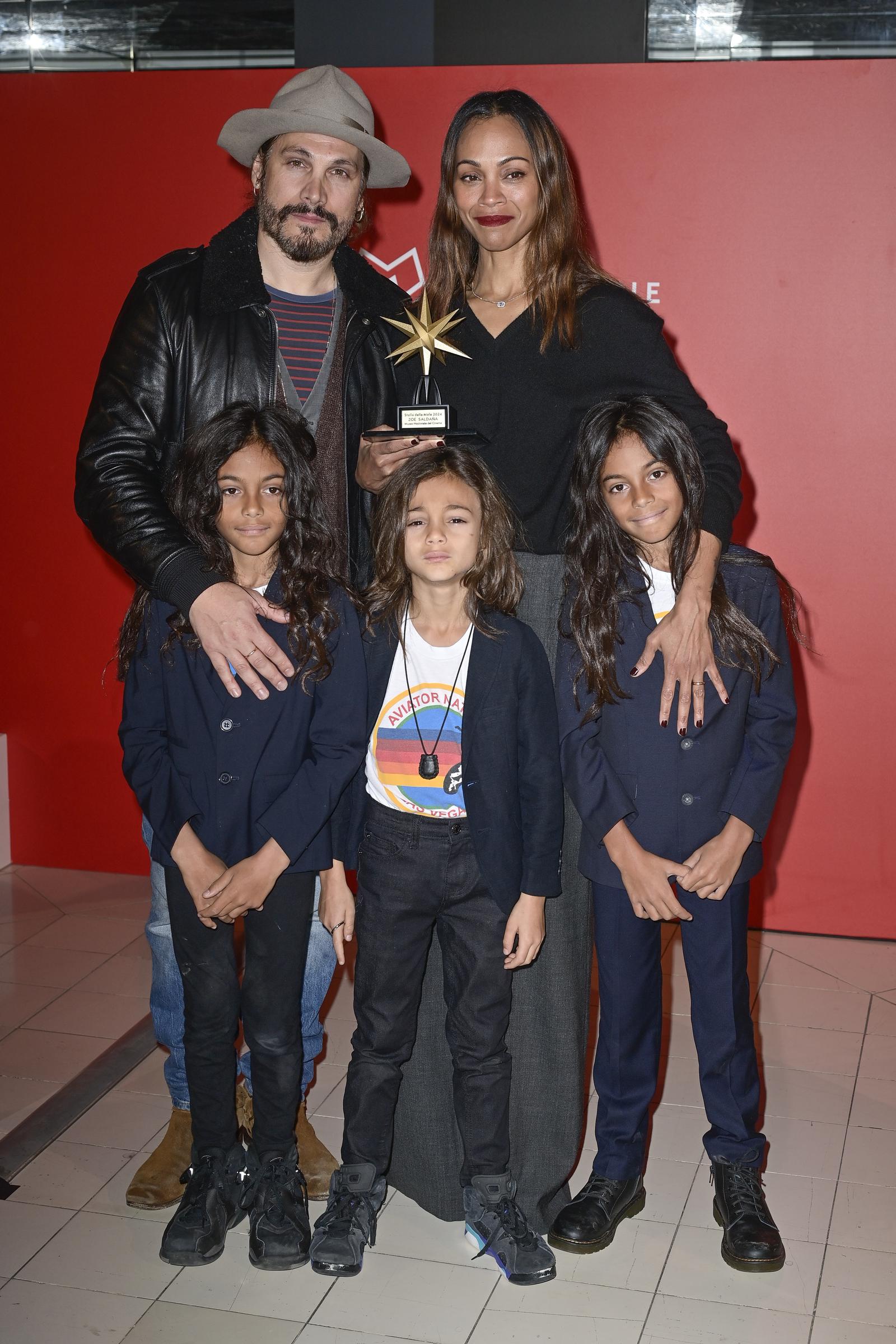 Marco Perego y Zoe Saldaña con sus hijos, Cy, Bowie y Zen Perego-Saldaña en el photocall del estreno de "Emilia Pérez". | Fuente: Getty Images