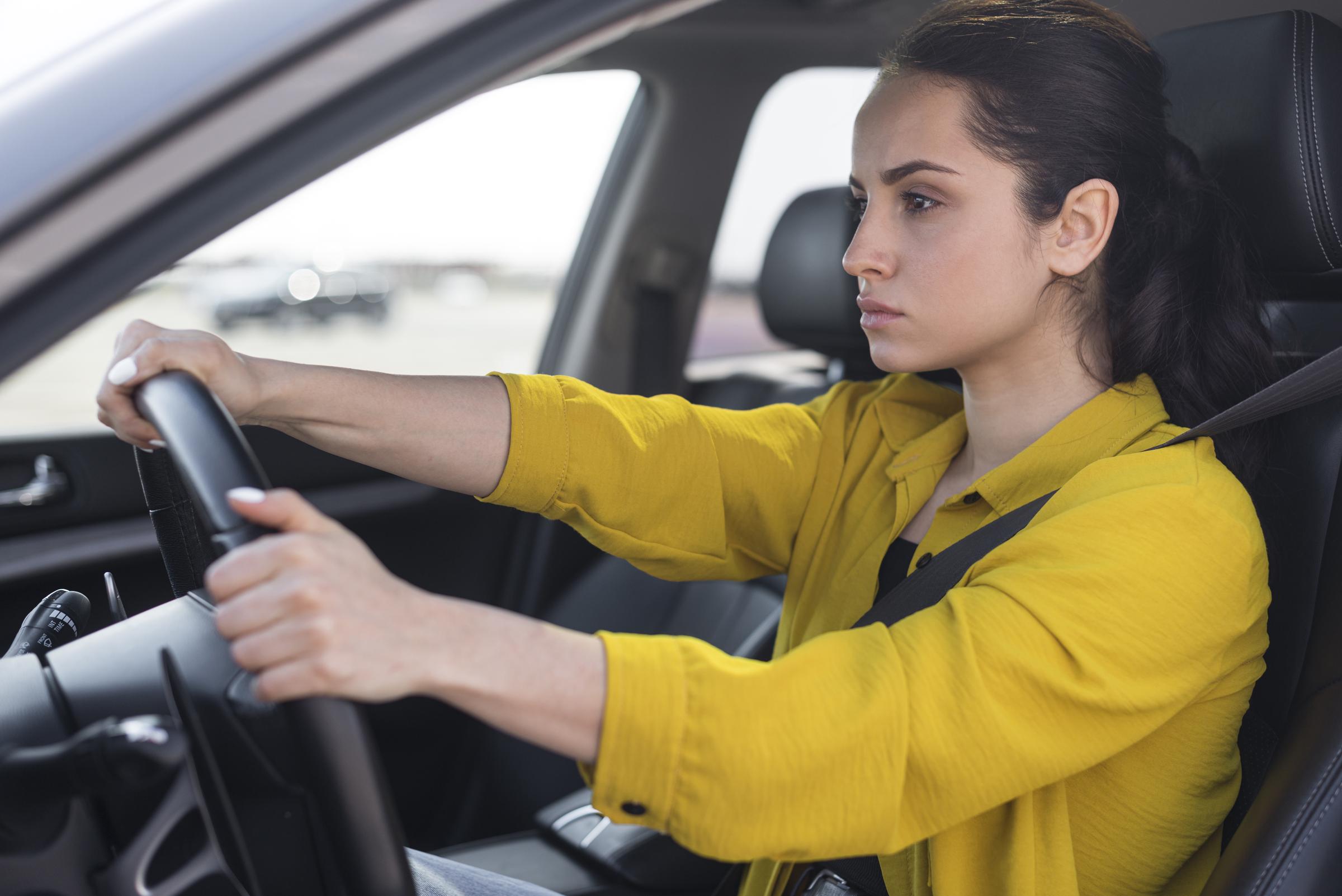 Una joven frustrada conduciendo un Automóvil | Fuente: Freepik