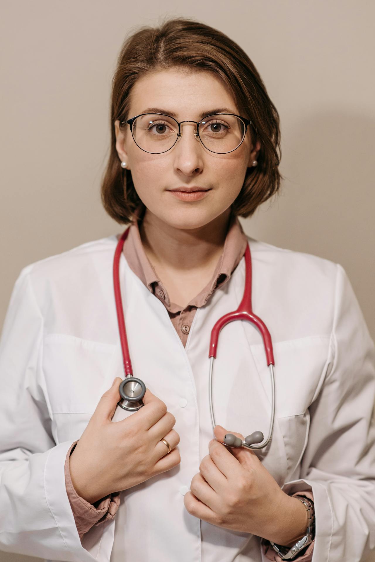 Un médico sujetando un estetoscopio | Fuente: Pexels