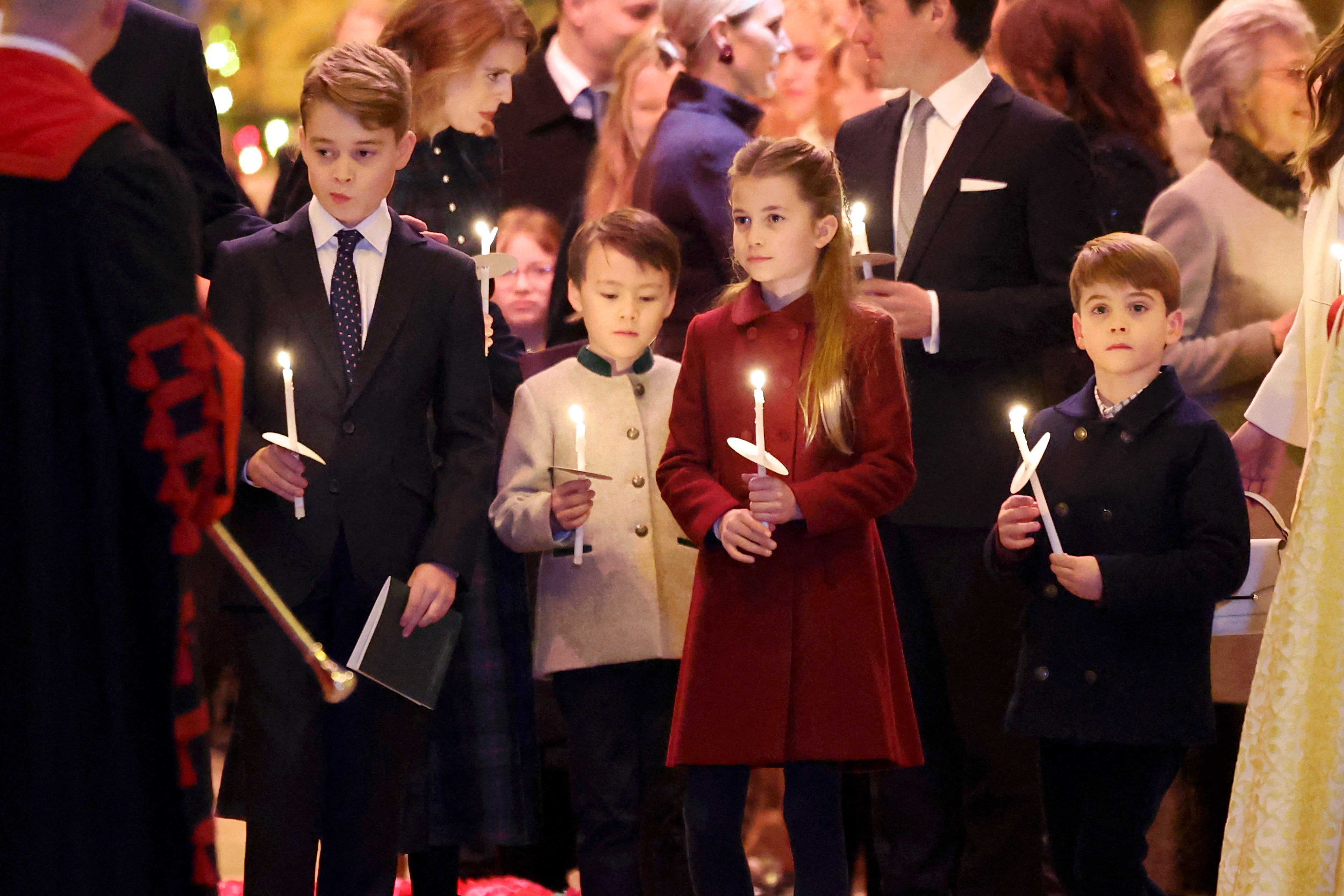 El príncipe George, Christopher Woolf Mapelli Mozzi, la princesa Charlotte y el príncipe Louis sostienen velas encendidas durante el Servicio de Villancicos "Juntos en Navidad" en la Abadía de Westminster el 8 de diciembre de 2023, en Londres. | Foto: Getty Images