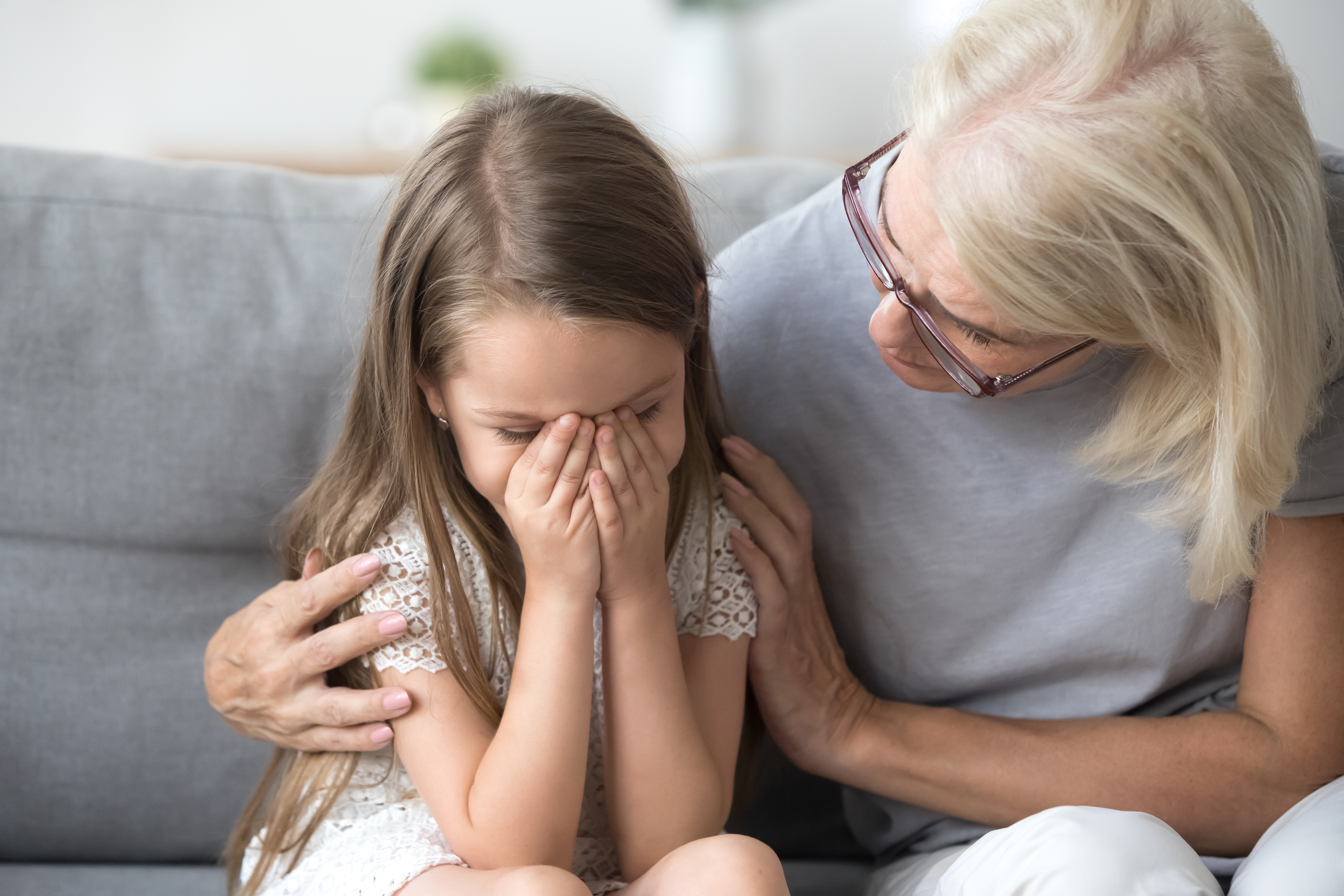 Mujer mayor consolando a una niña | Foto: Shutterstock