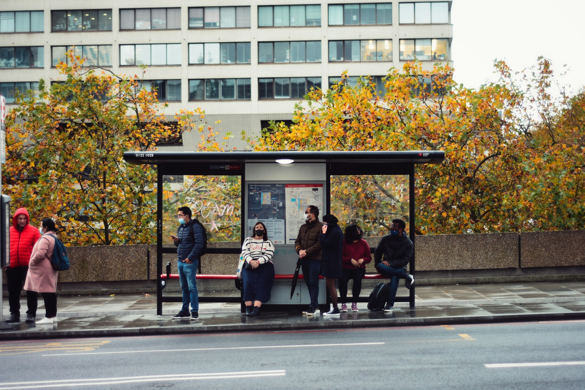 Gente esperando el autobús en una parada | Foto: Unsplash