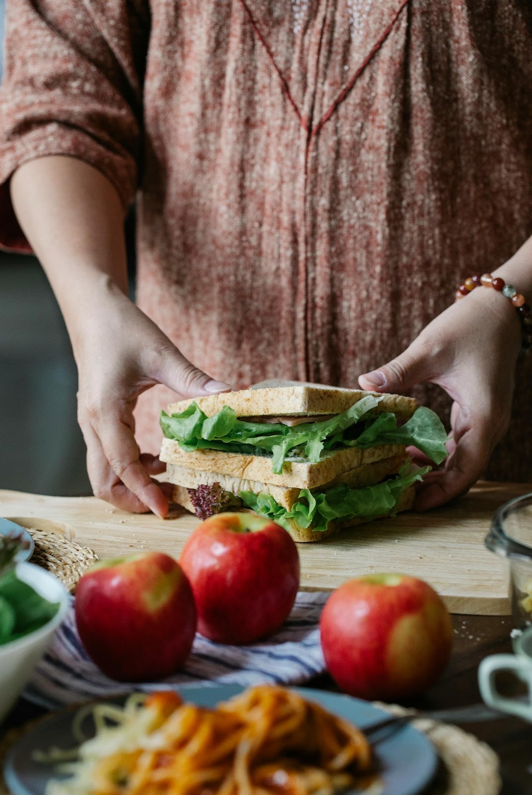 Primer plano de una mujer preparando un bocadillo | Fuente: Pexels