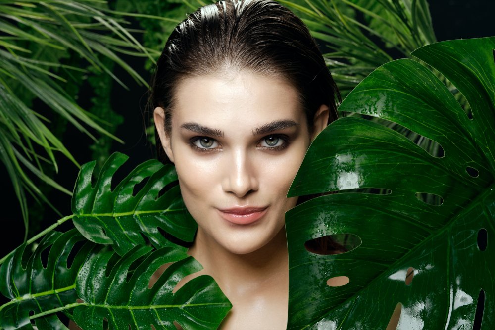 Mujer con el cabello húmedo rodeada de vegetación. | Foto: Shutterstock