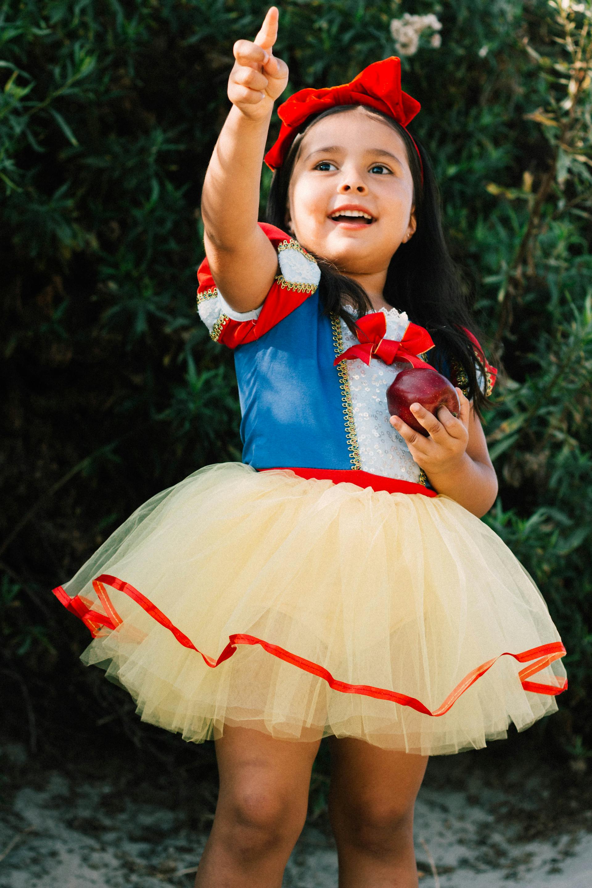 Una niña sonriente con un disfraz de princesa | Fuente: Pexels