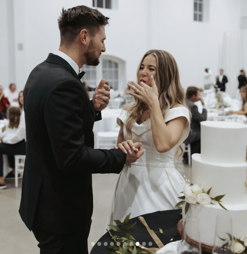 Stephen Wissmann y Jana Duggar prueban un trozo de su pastel de boda cortado, publicado en agosto de 2024 | Fuente: Instagram/janamduggar