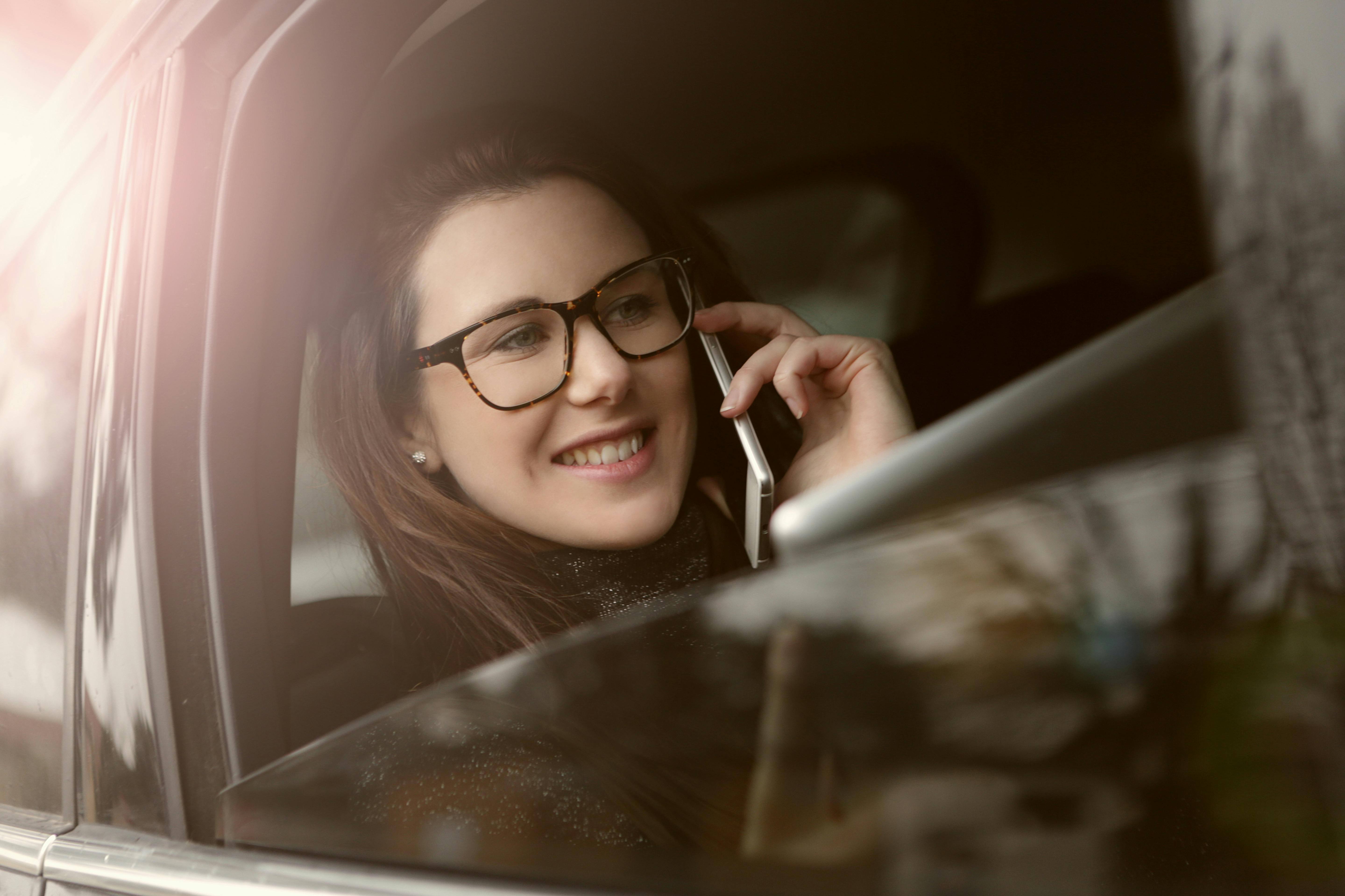 Una mujer sonriendo mientras habla por teléfono | Foto: Pexels