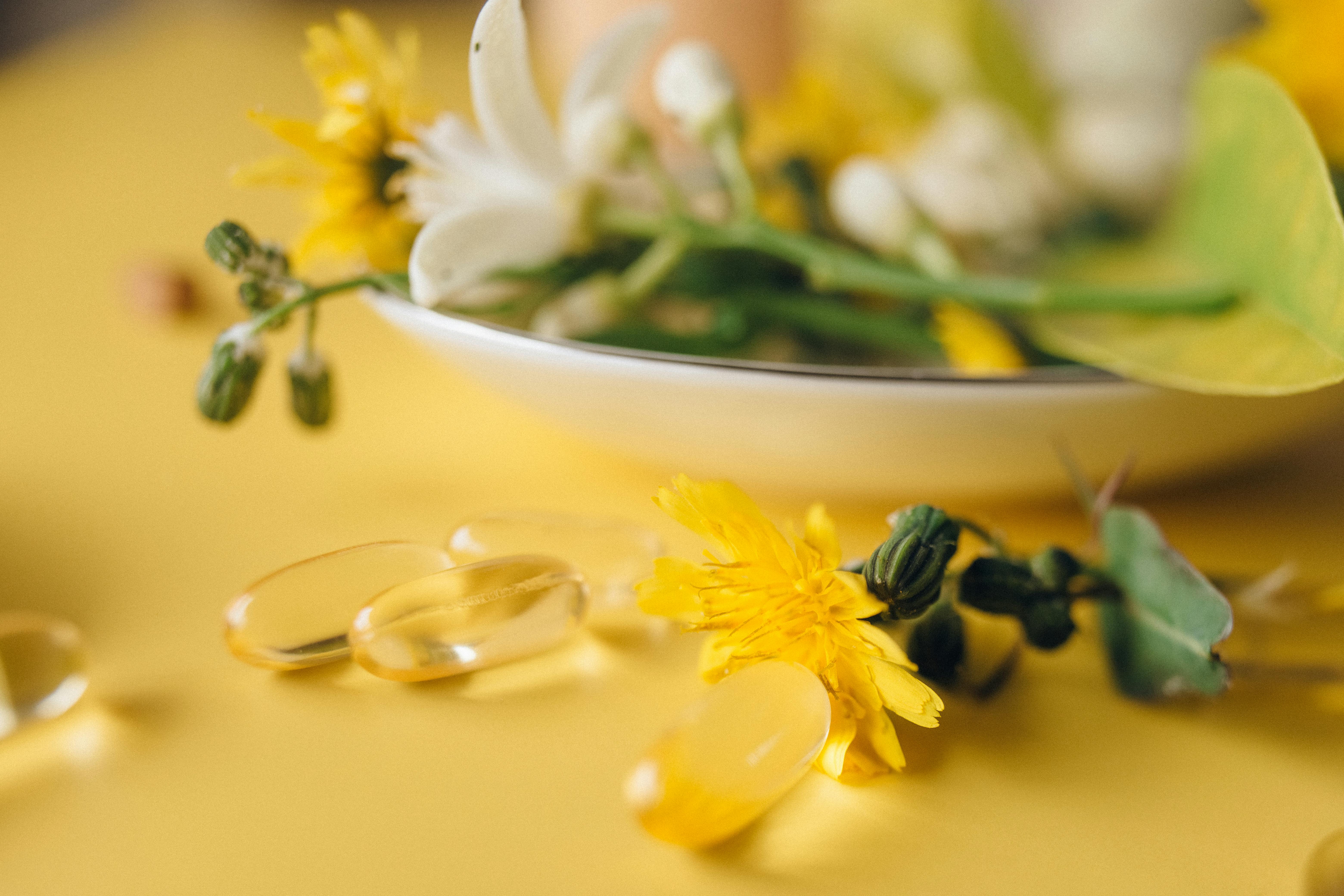 Pastillas de vitaminas sobre fondo amarillo | Fuente: Pexels