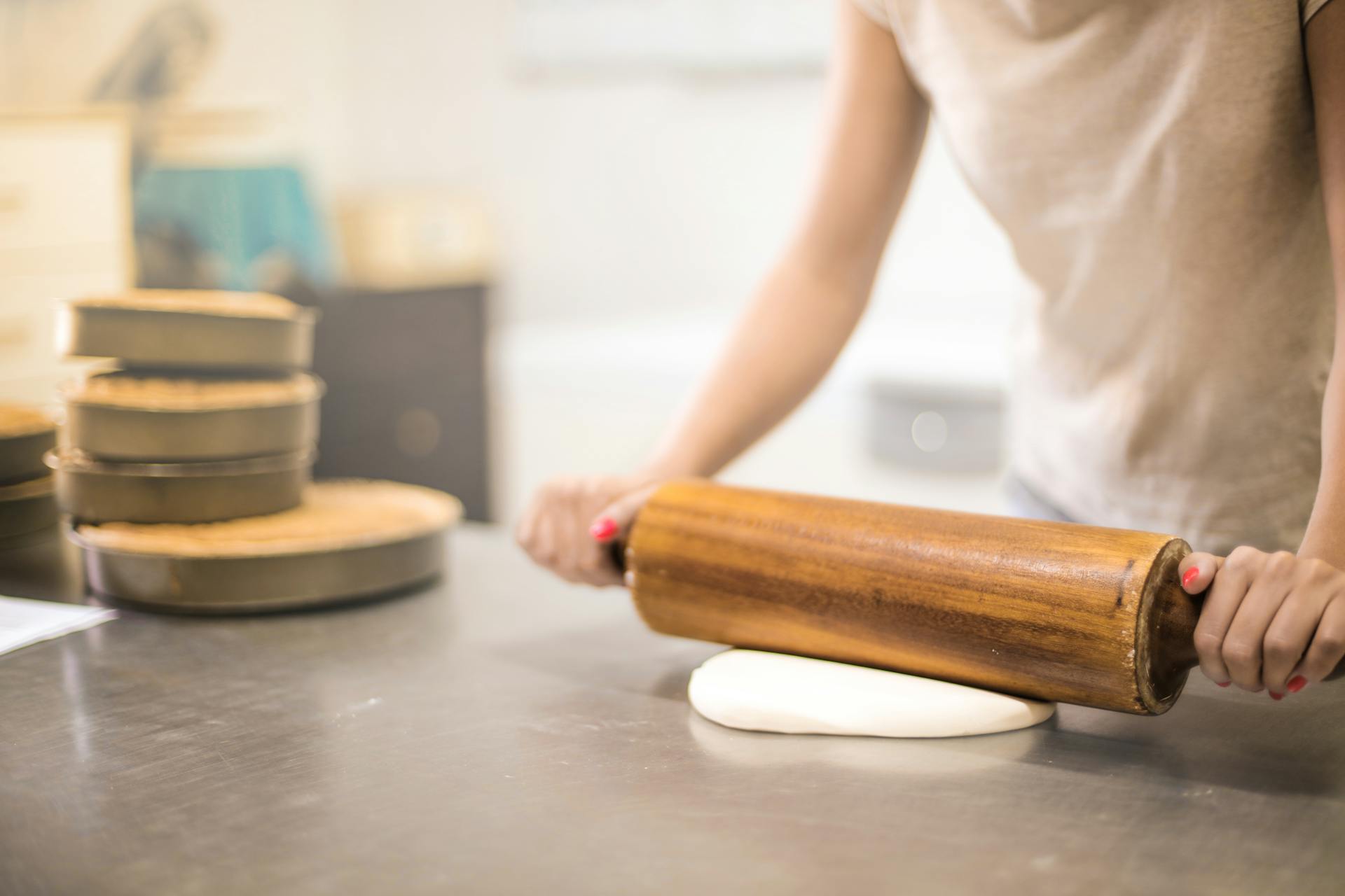 Una mujer extendiendo masa | Fuente: Pexels