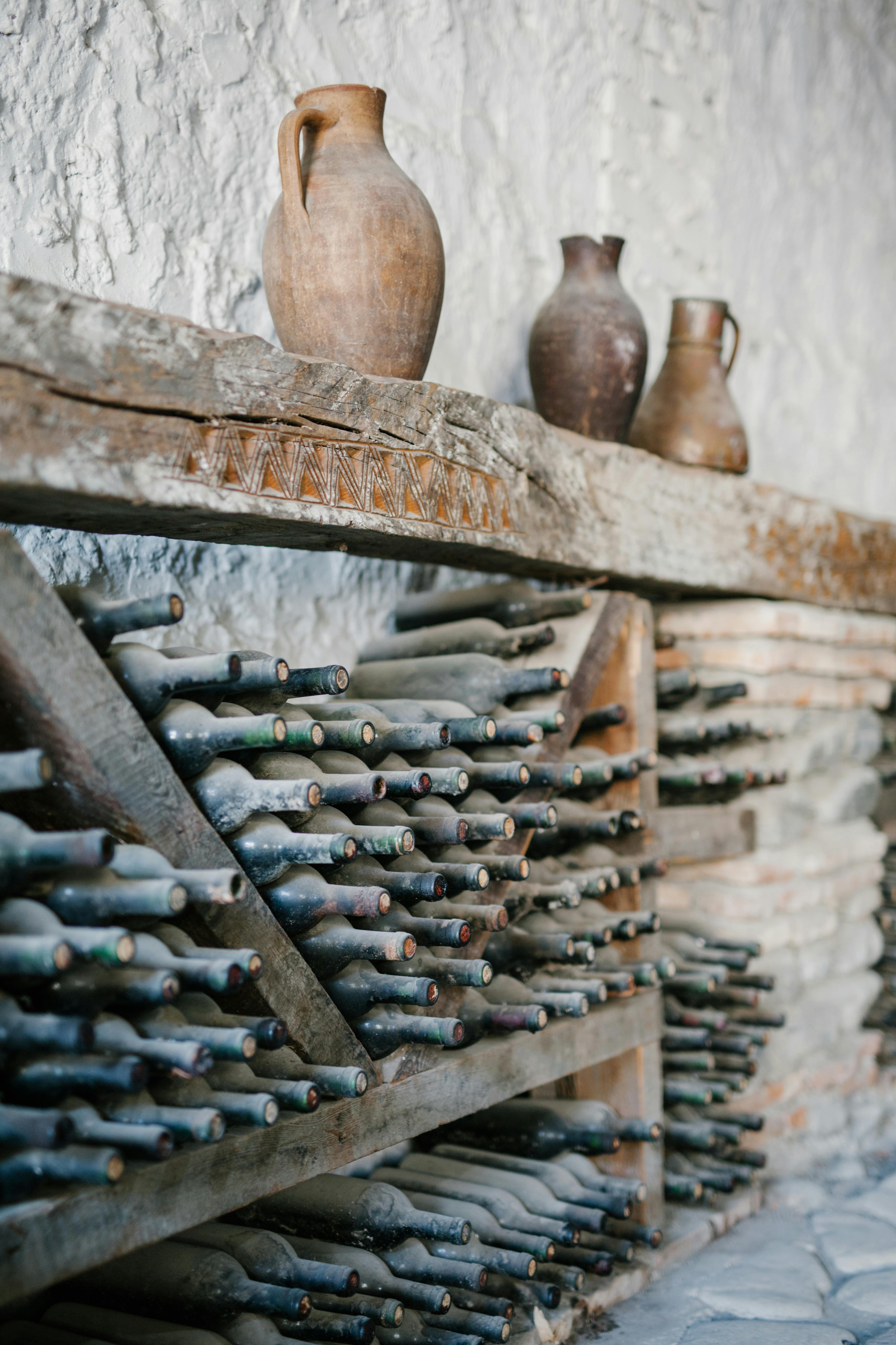 Estanterías de madera con polvorientas botellas de vino | Foto: Pexels