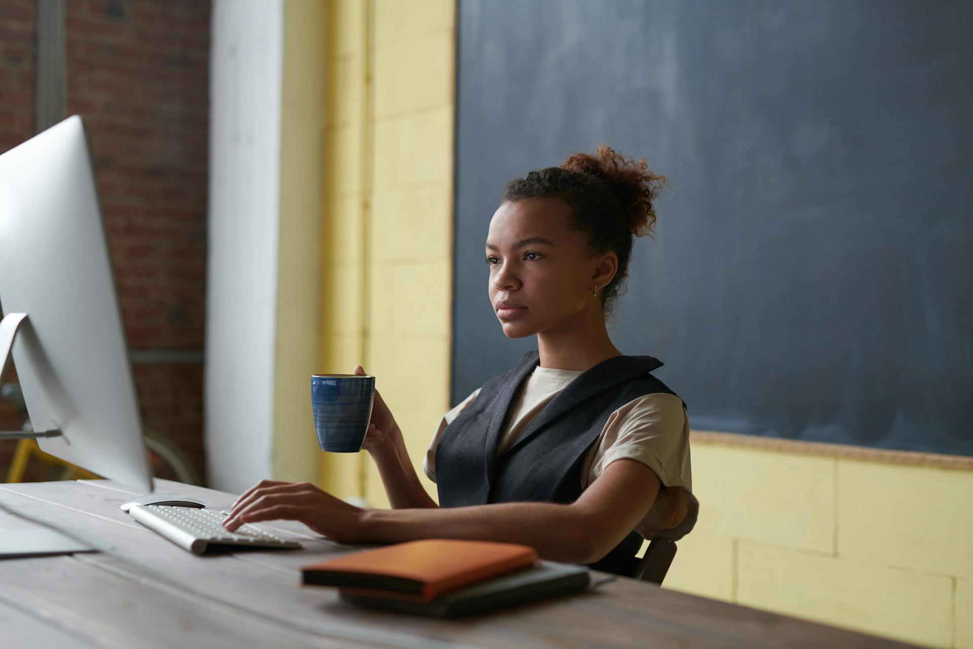 Una profesora trabajando en su mesa | Fuente: Pexels