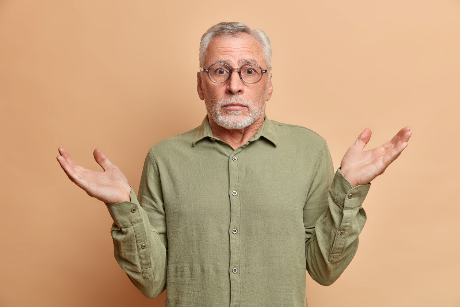 Un hombre mayor encogiéndose de hombros | Fuente: Freepik