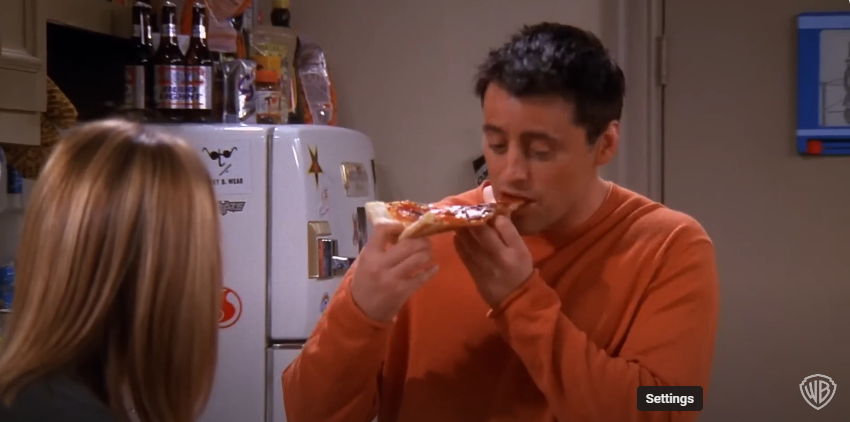 Matt LeBlanc como Joey en el plató de "Friends" comiendo pizza | Fuente: YouTube/@warnerbrostv