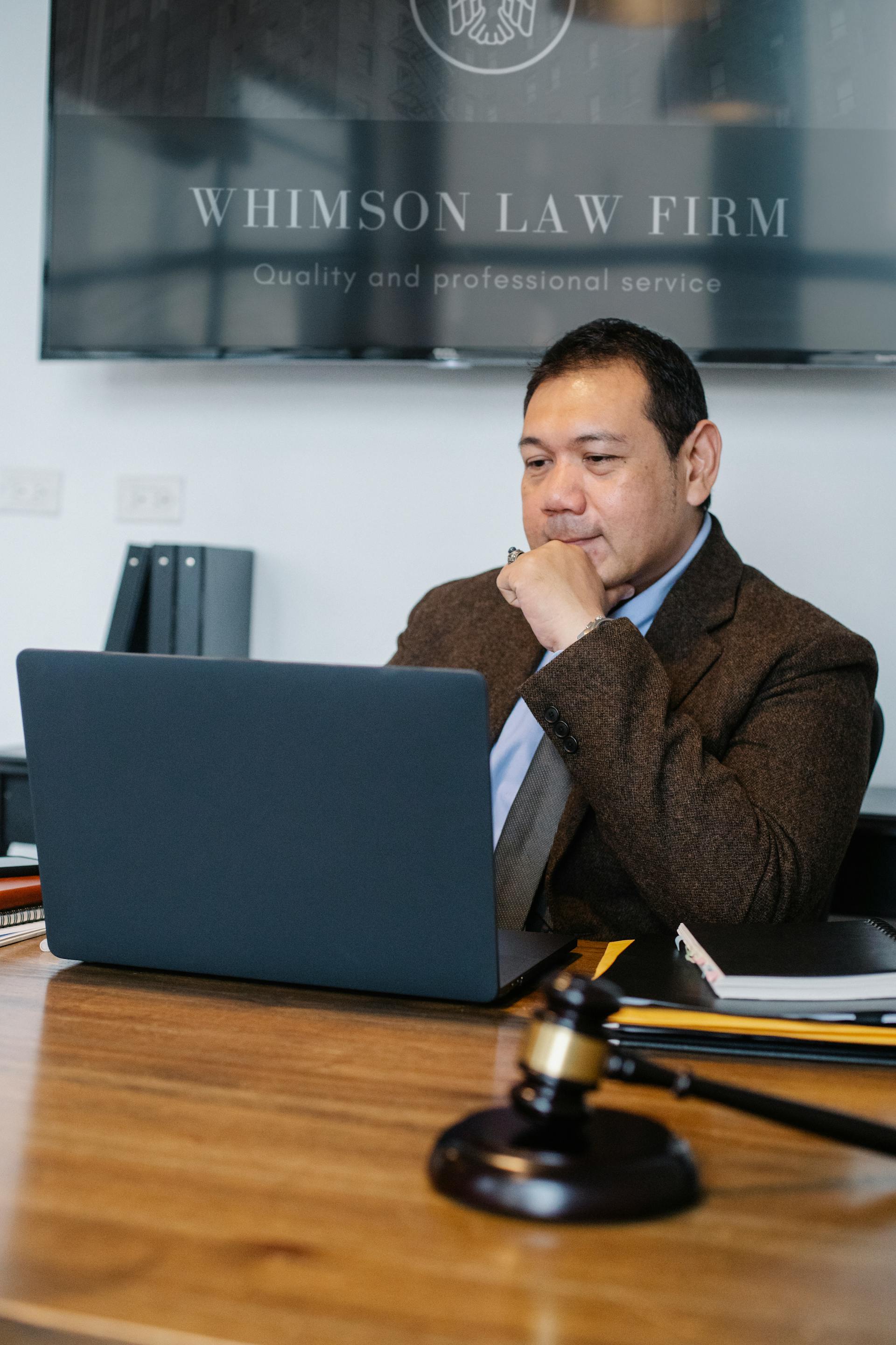 Hombre con un portátil en su despacho | Fuente: Pexels