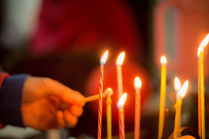 Persona enciende velas de cumpleaños. | Foto: Pixnio 