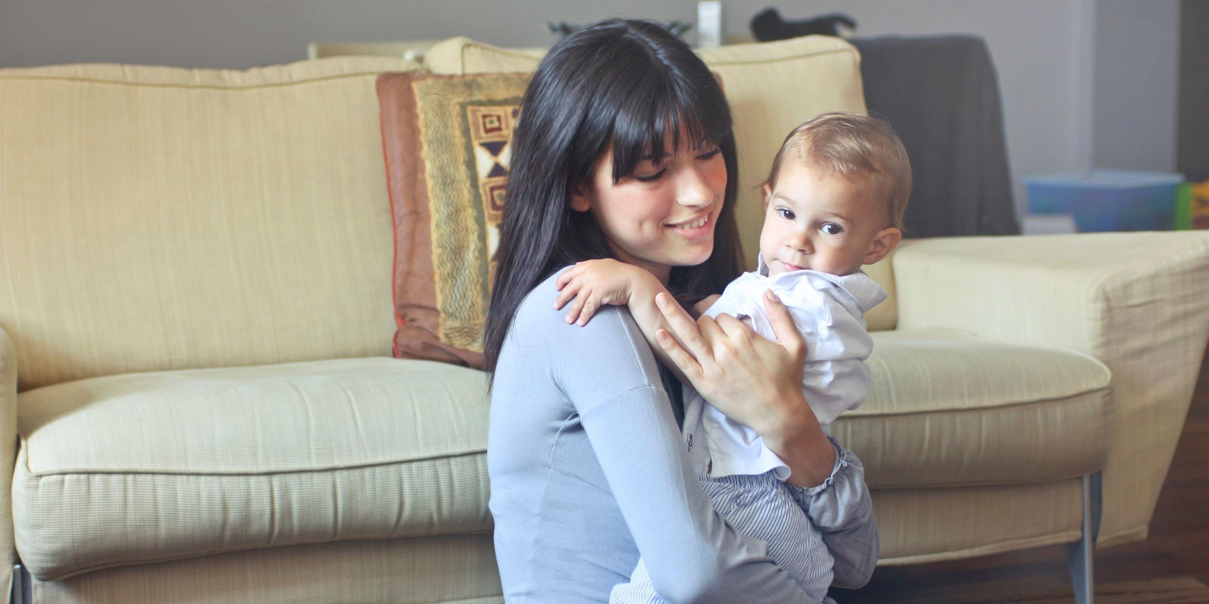 Una madre abrazando con cariño a su bebé en casa | Fuente: Pexels