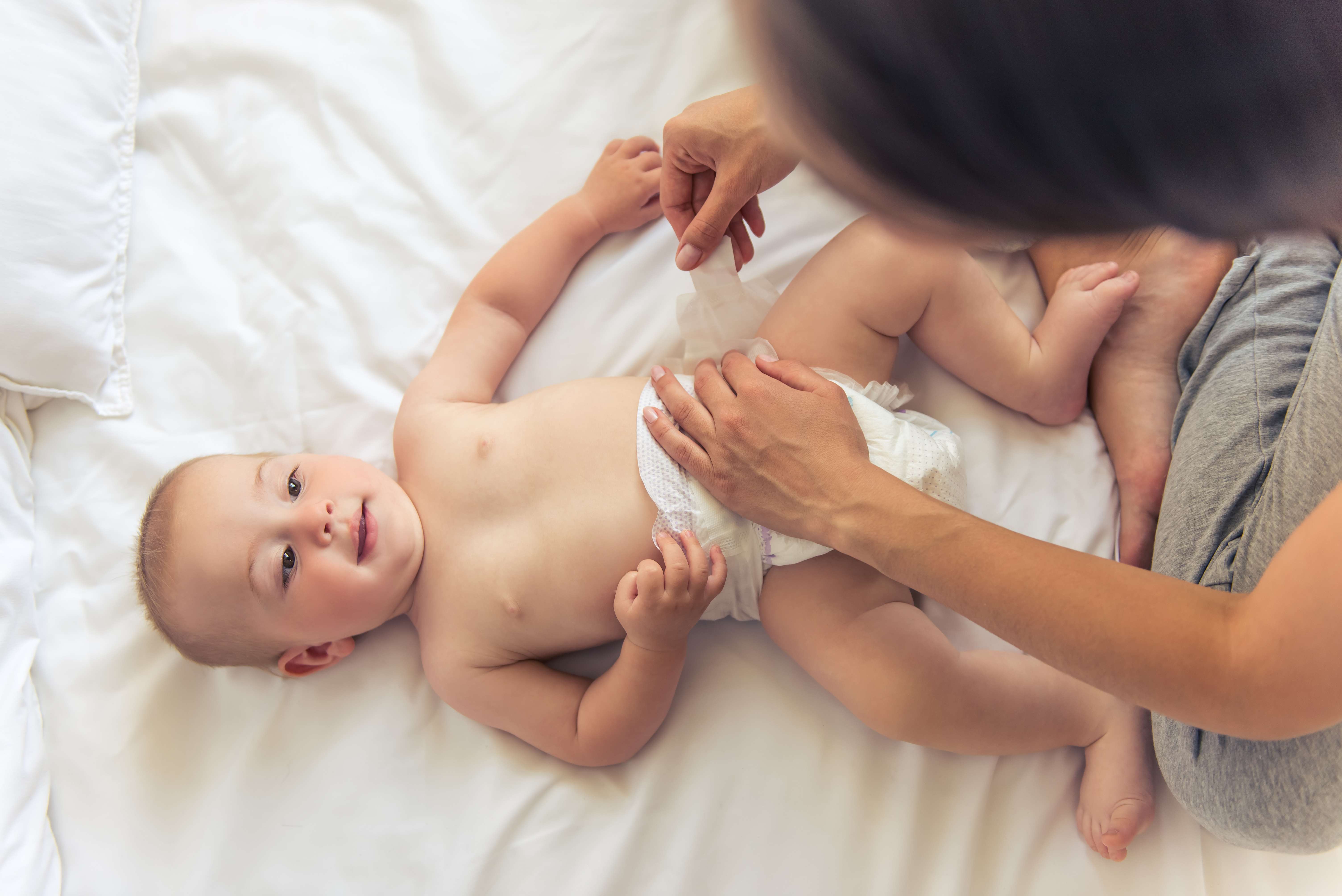 Una mujer cambiando el pañal a un bebé. | Foto: Shutterstock