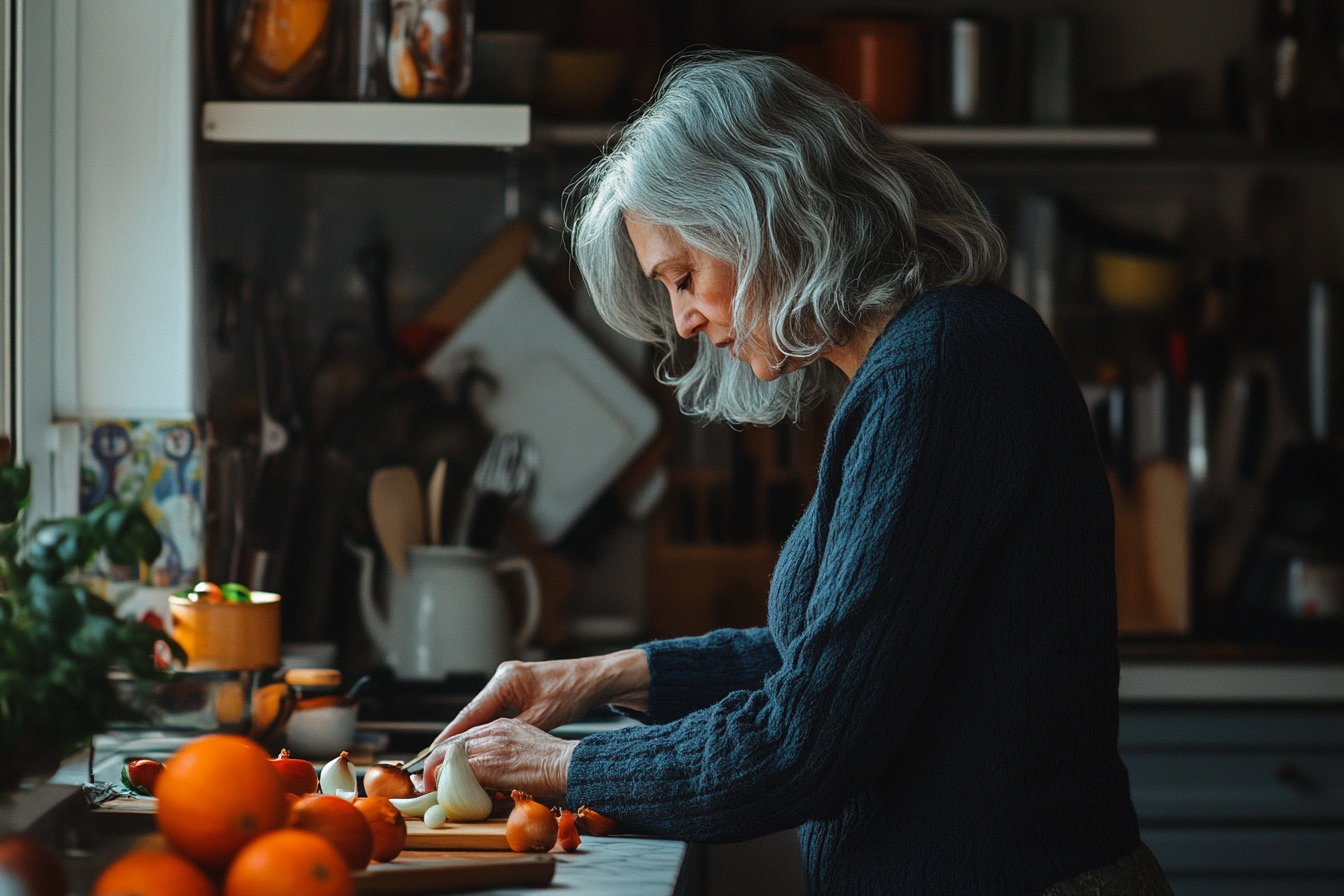 Mujer mayor cortando ingredientes | Fuente: Midjourney