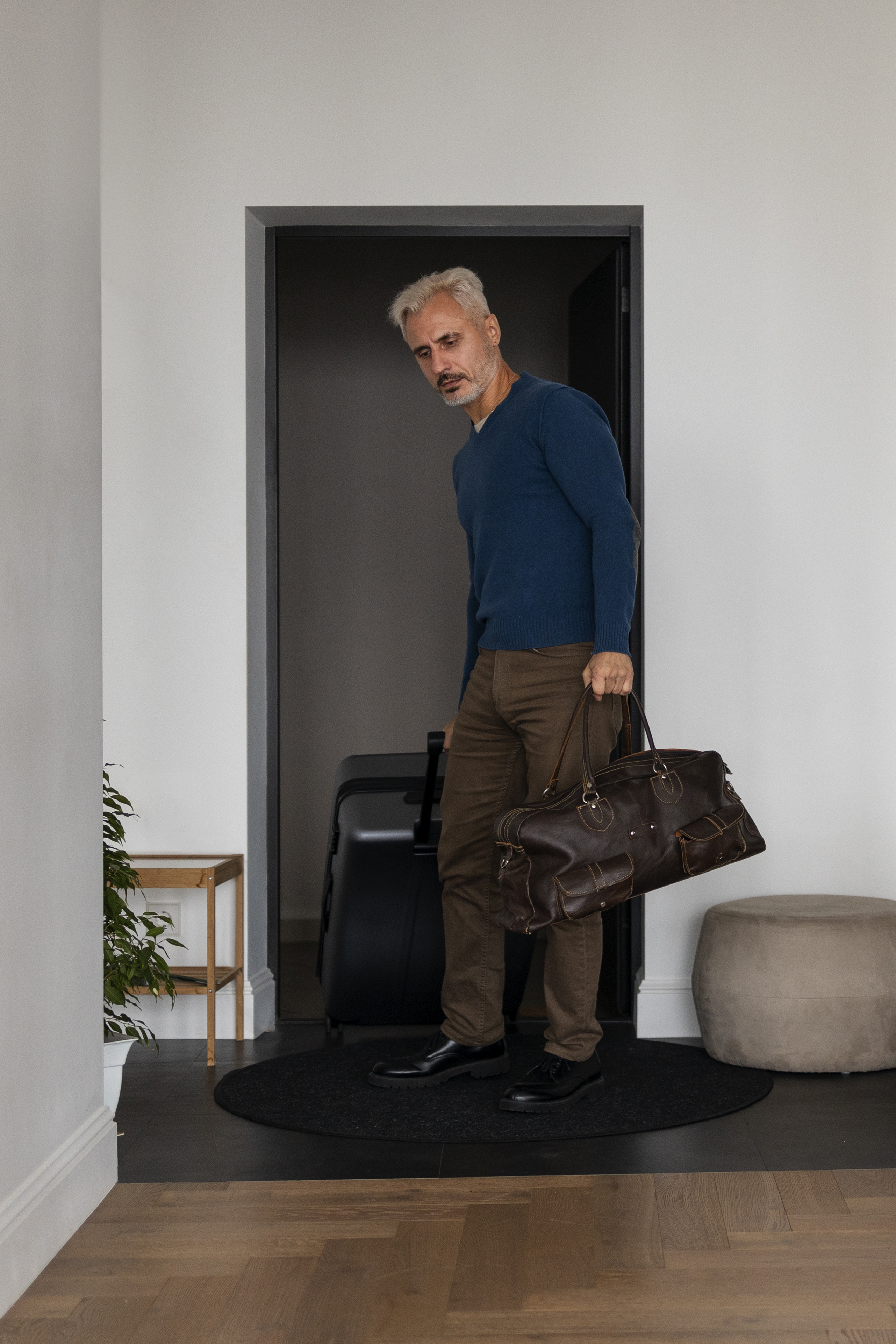 Un uomo che entra in una casa con i bagagli | Fonte: Freepik