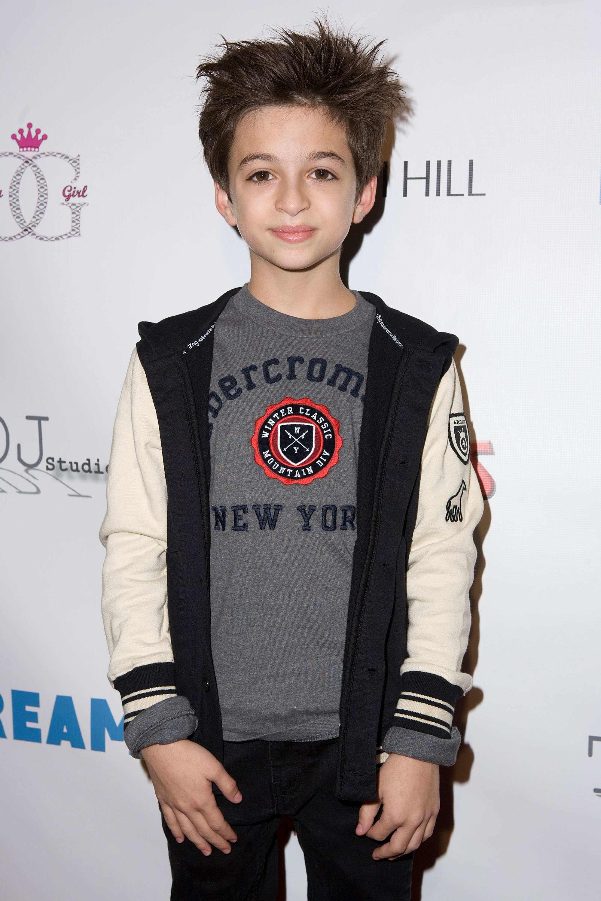 El joven artista asiste a la 2ª edición de la fiesta "Winter Wonderland" de la revista Dream en Los Ángeles, California, vestido con una camiseta gris con estampado, una chaqueta negra y crema y unos pantalones negros. | Fuente: Getty Images