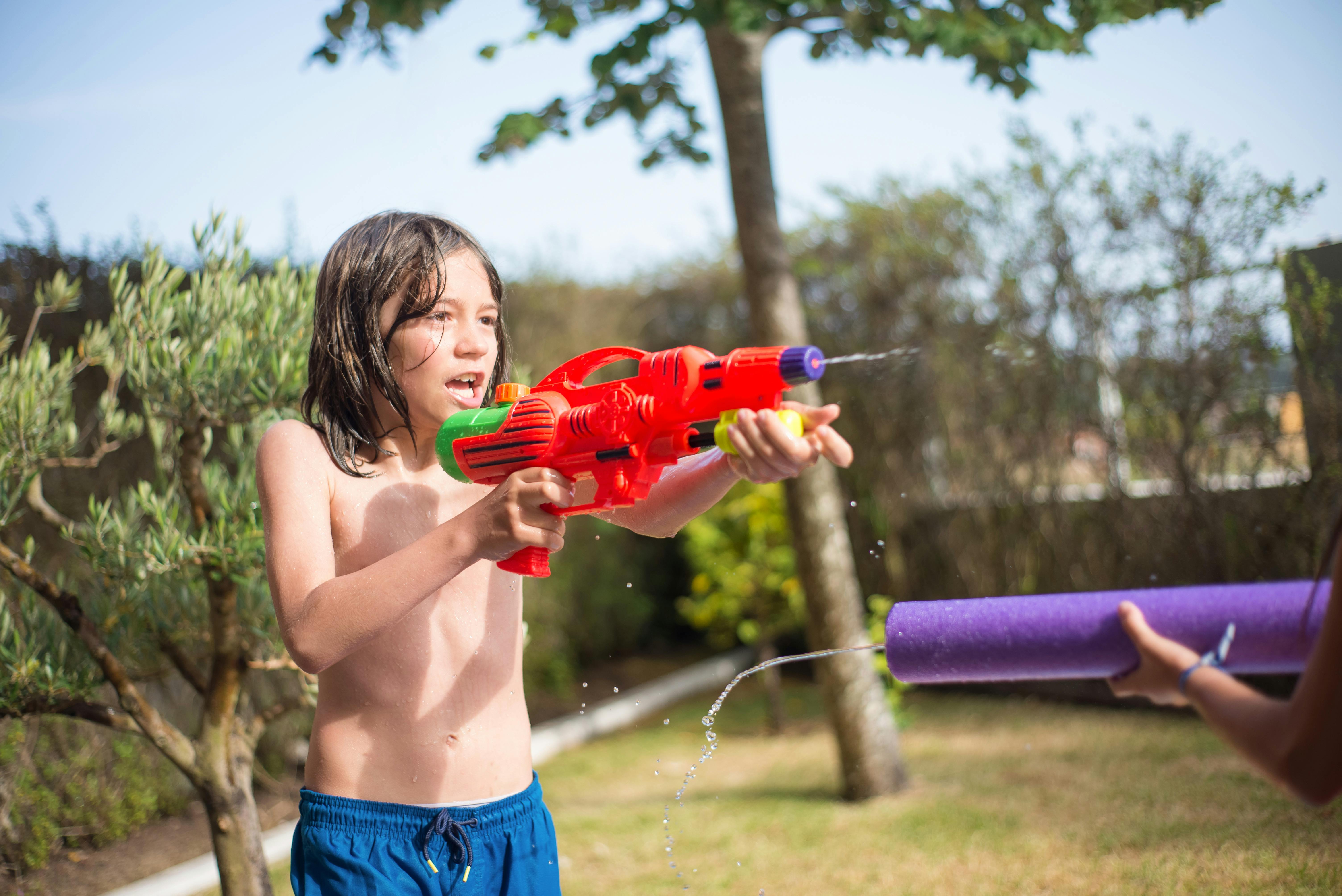 Un niño jugando con una pistola de agua | Fuente: Pexels