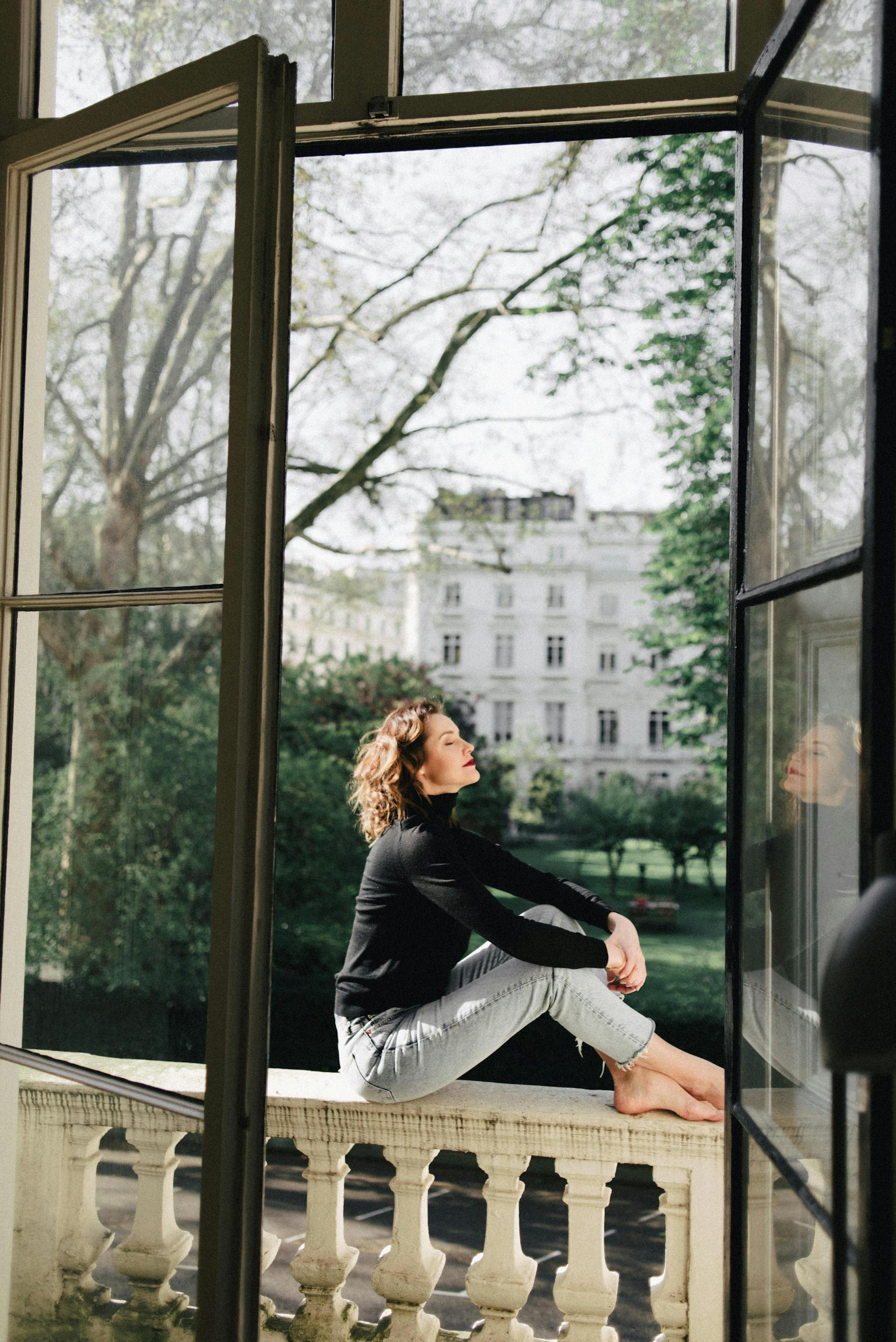 Una mujer sentada en un balcón | Fuente: Pexels