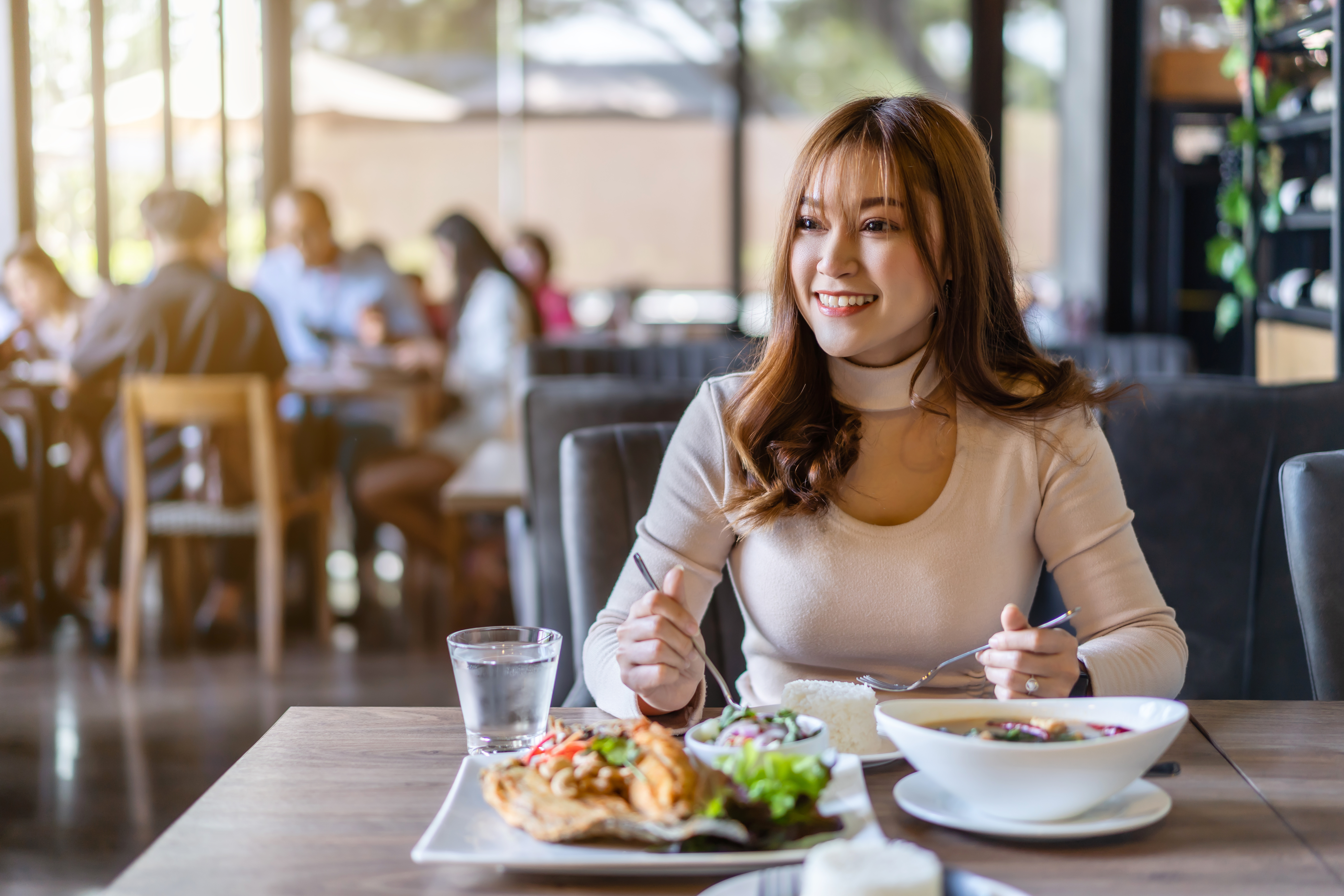 Una mujer comiendo en un restaurante | Foto: Shutterstock