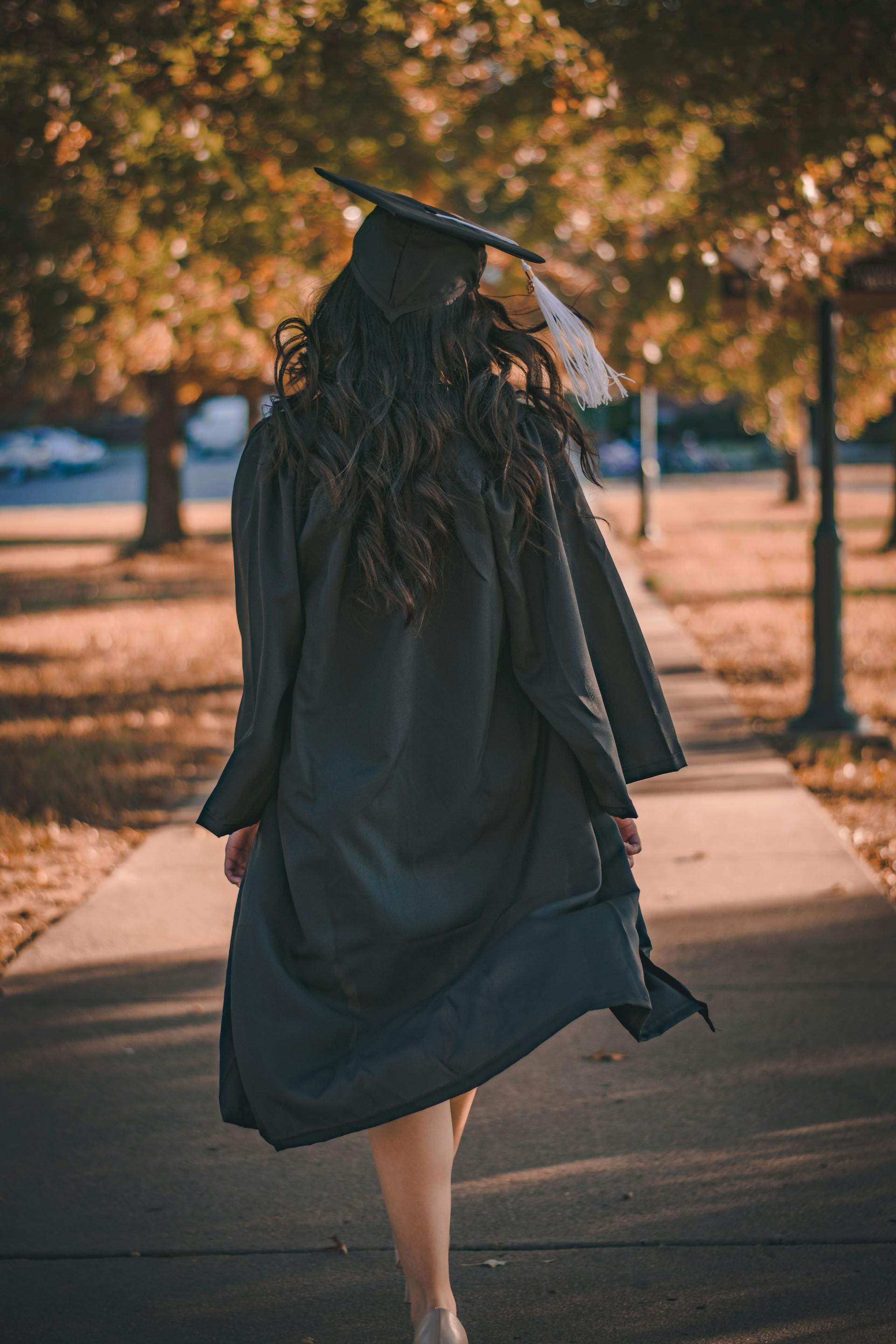 Una mujer vestida con toga y birrete para su graduación | Fuente: Pexels