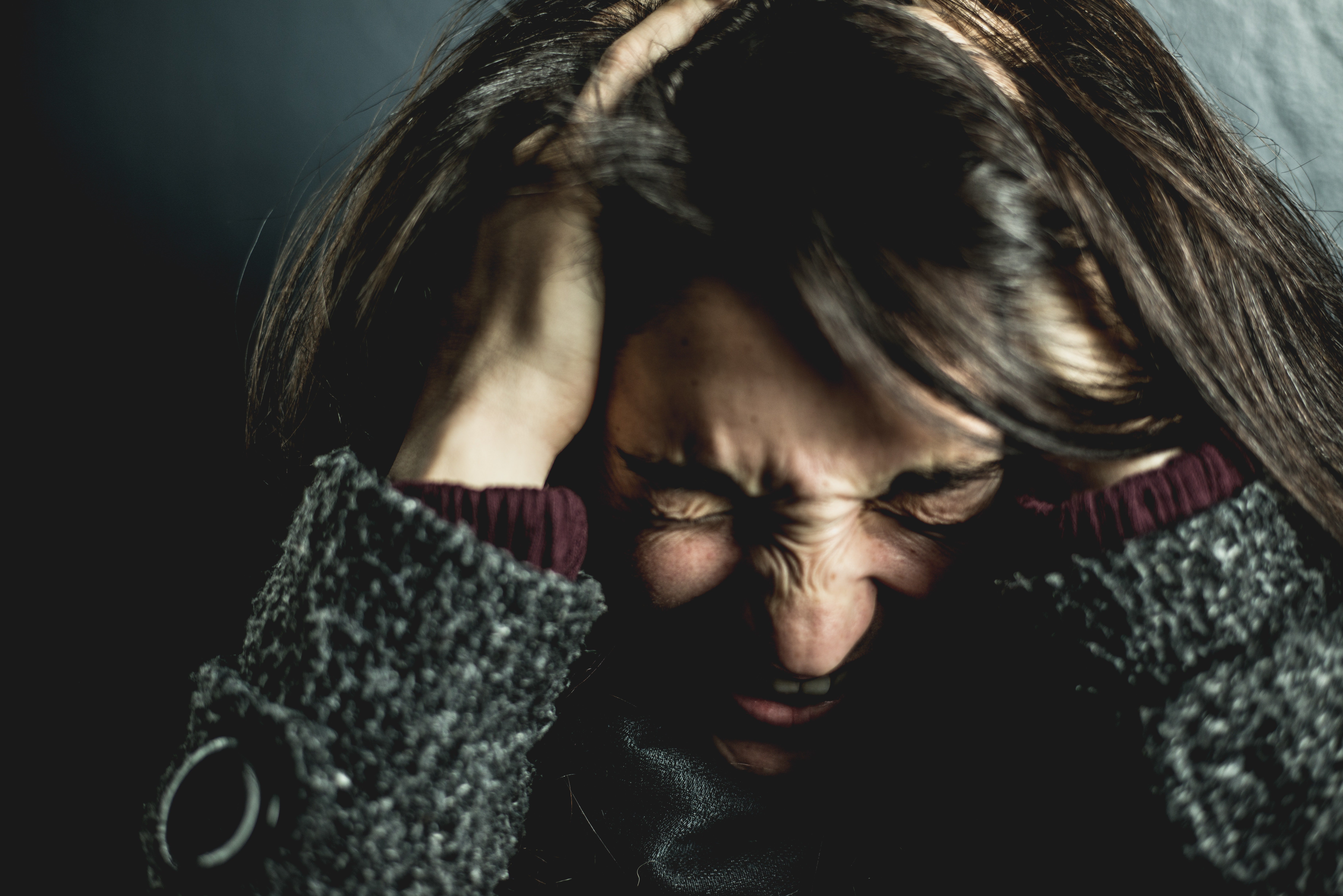Mujer enojada con los ojos cerrados y sus manos en su cabeza. | Foto: Pexels