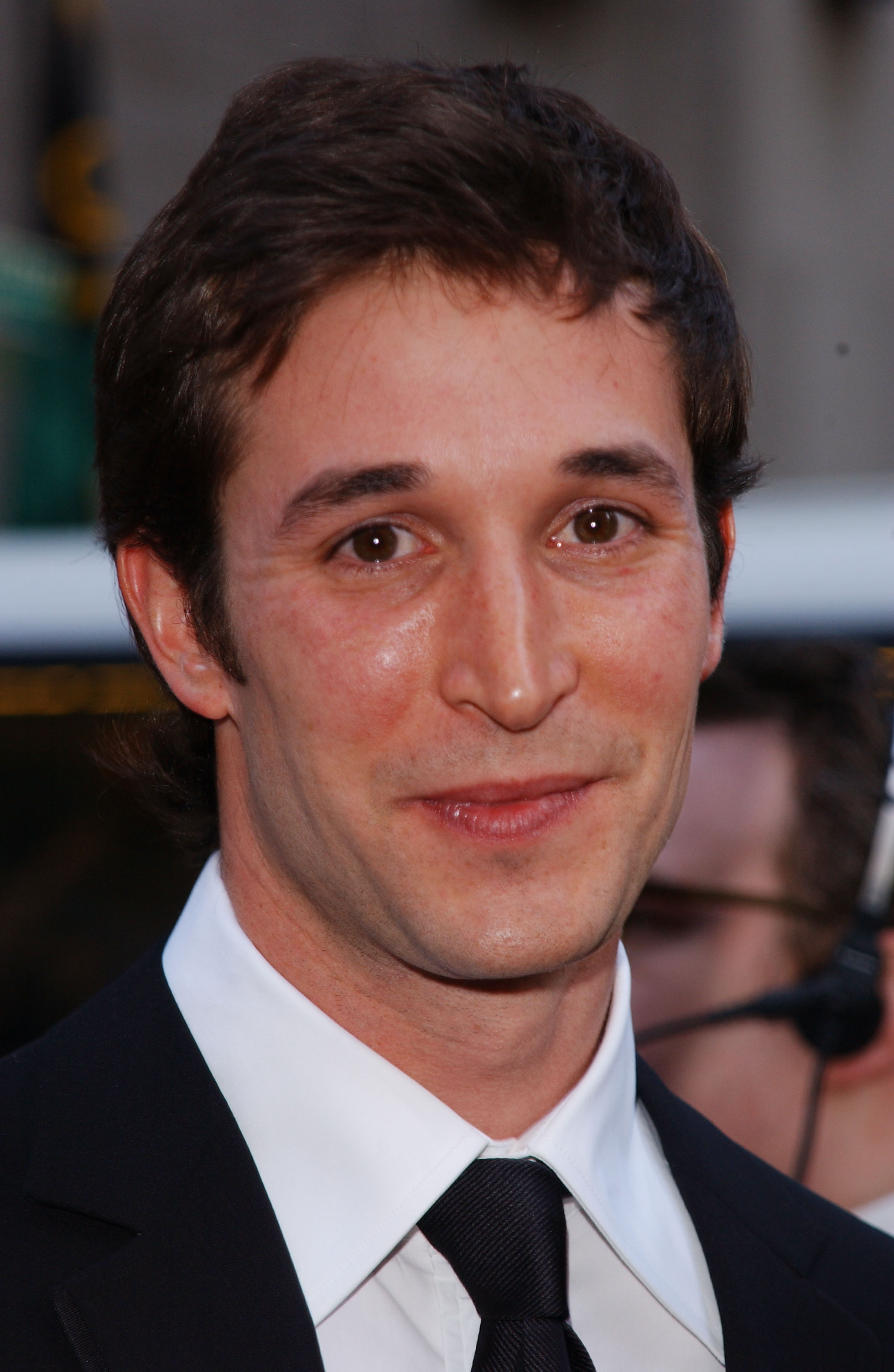 Noah Wyle asiste a un evento de alfombra roja en su juventud, vestido con un traje negro clásico, camisa blanca y corbata. | Fuente: Getty Images