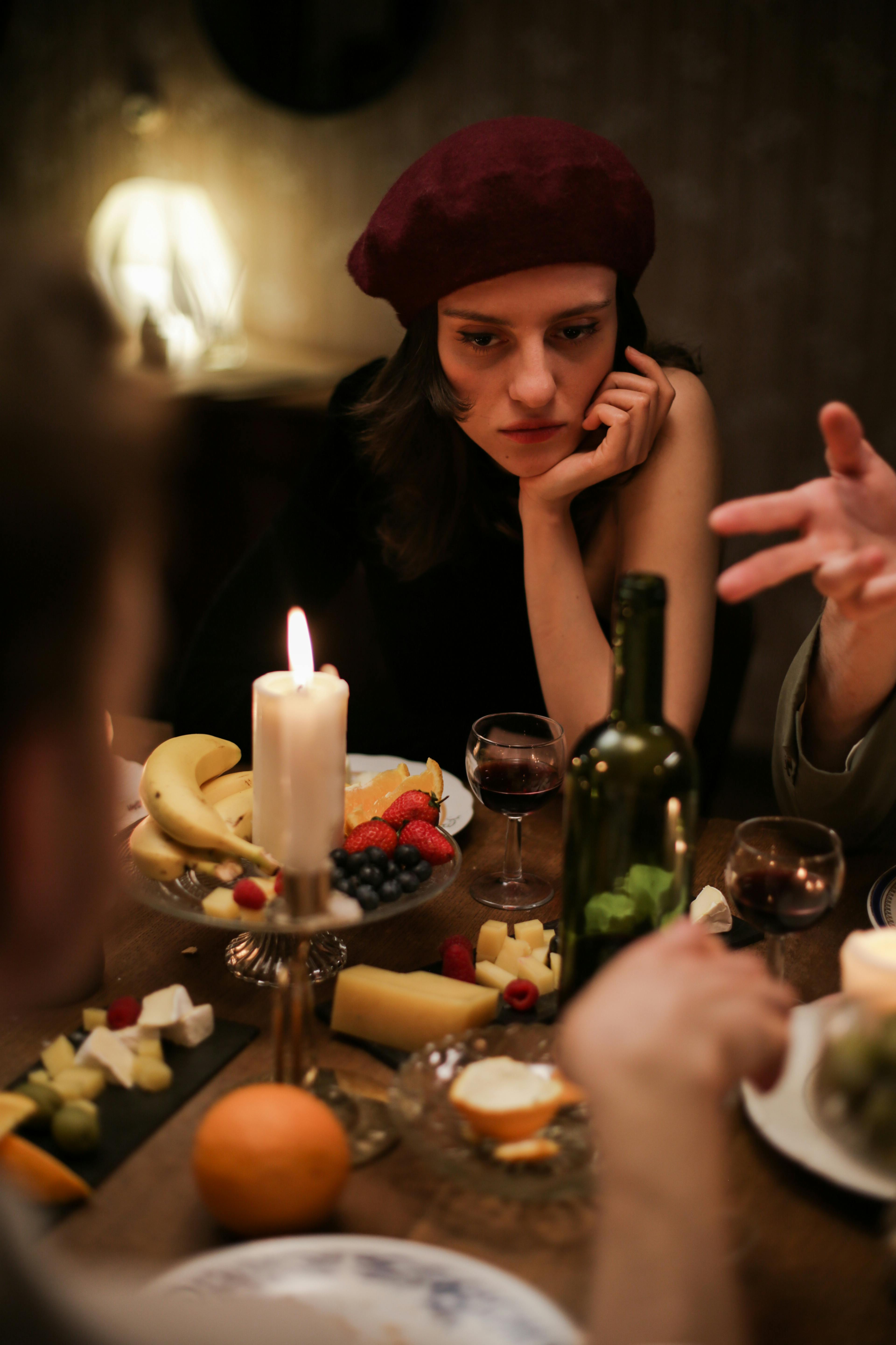 Una mujer expresando su infelicidad en la mesa | Foto: Pexels