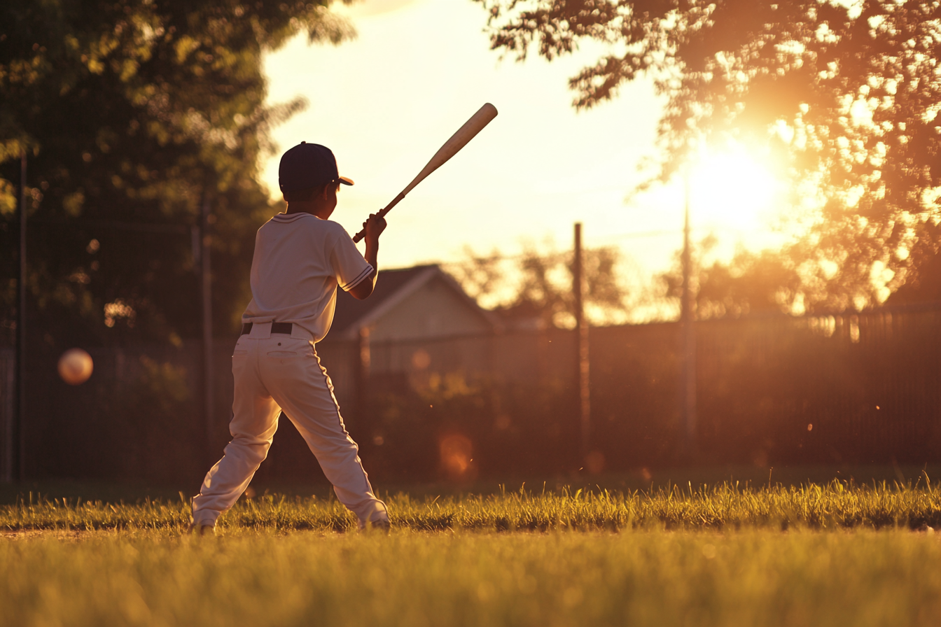 Un niño sujetando un bate de béisbol | Fuente: Midjourney